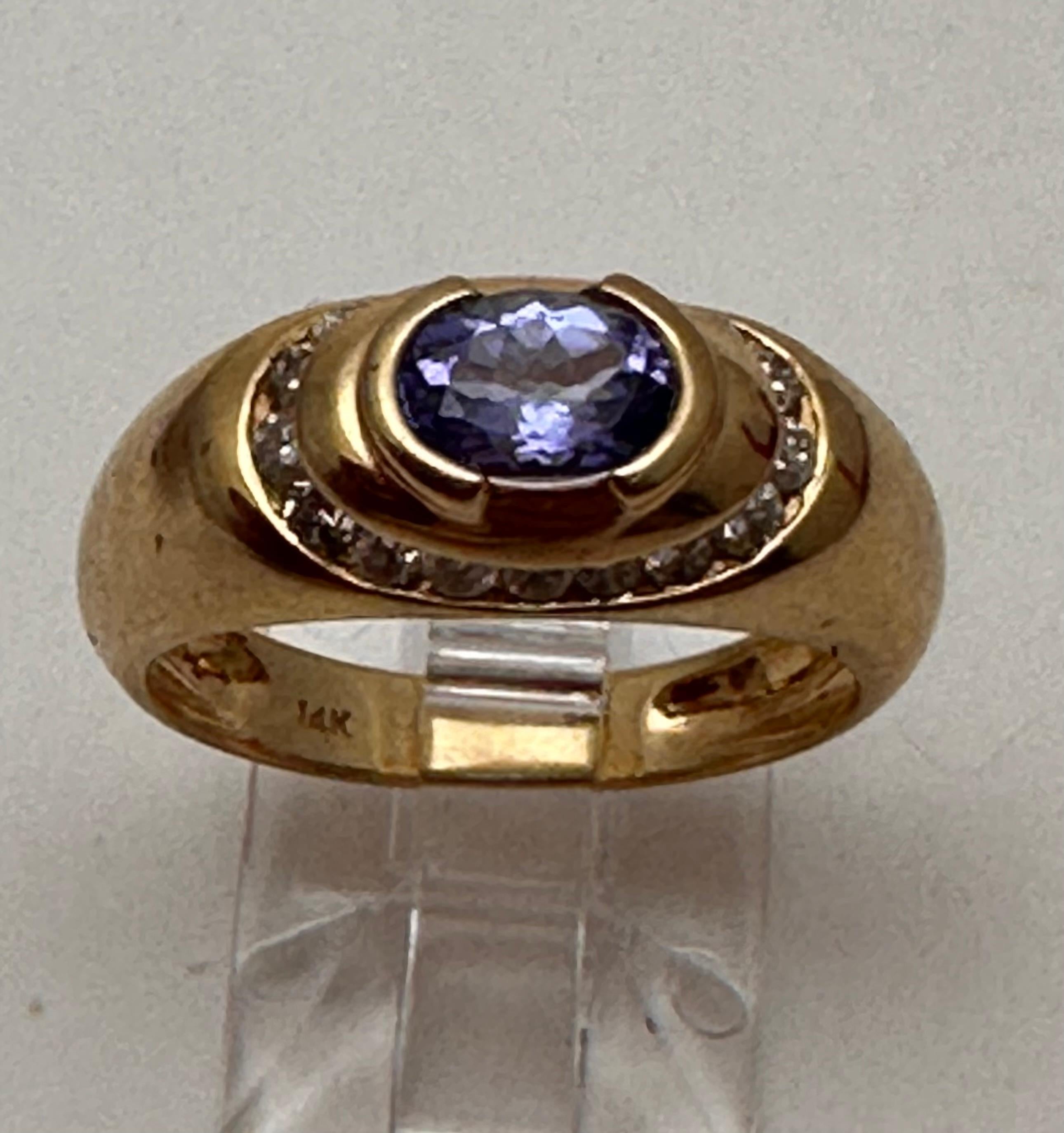14k Yellow Gold 4mm x 6mm Oval Tanzanite 
surrounded by 17 Diamonds  
Ring Size 6 1/2

Tanzanite 

Tanzanite changes colors when it is viewed from different directions. This shifting of colors has been said to facilitate raising consciousness. It