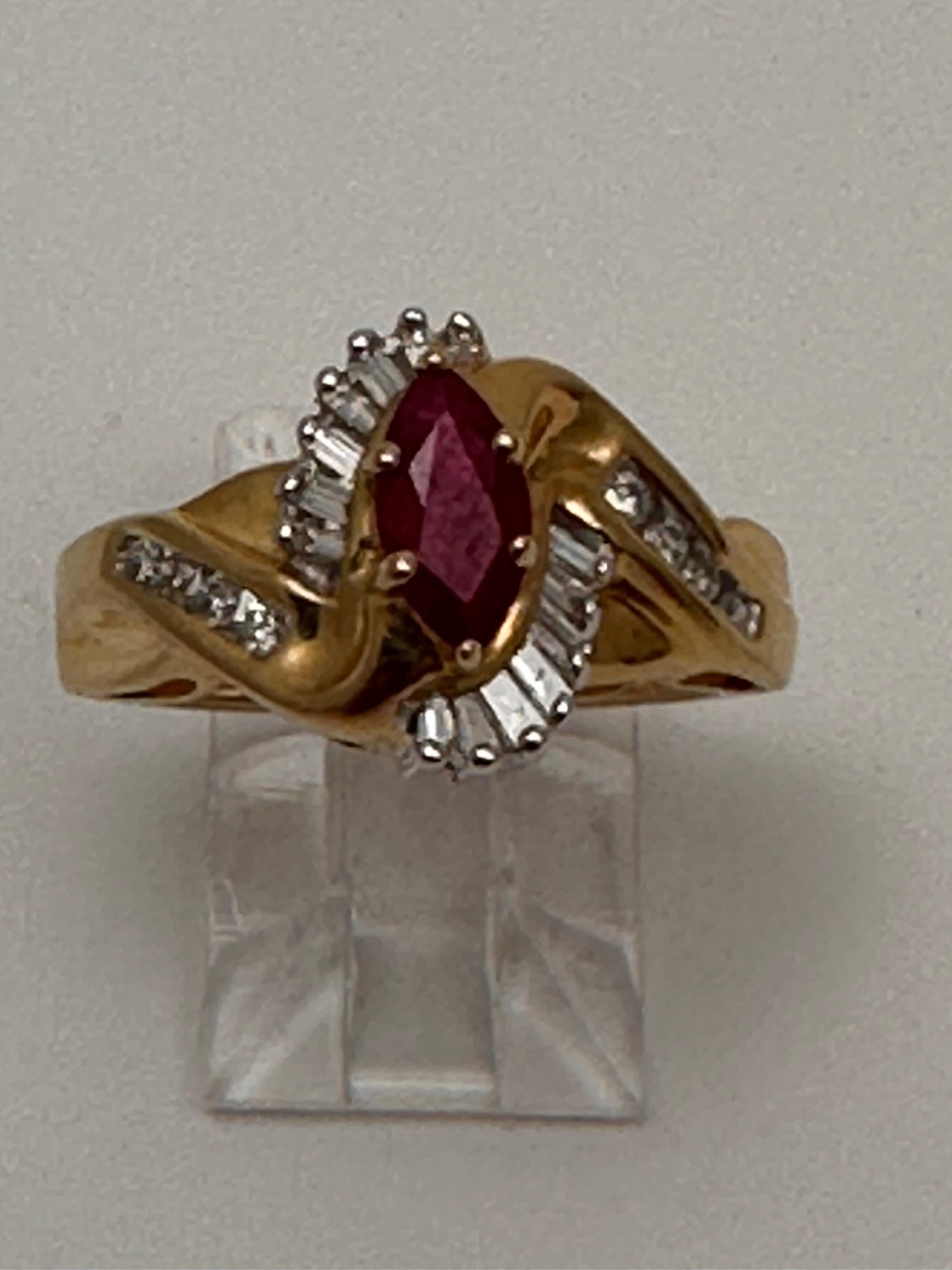 14k Yellow Gold approx. 4mm x 8mm Marquise Ruby wtih baguettes and round Diamonds
Ring Size 7

Ruby is believed to promote loving, nurturing, health, knowledge and wealth. It has been associated with improved energy and concentration, creativity,