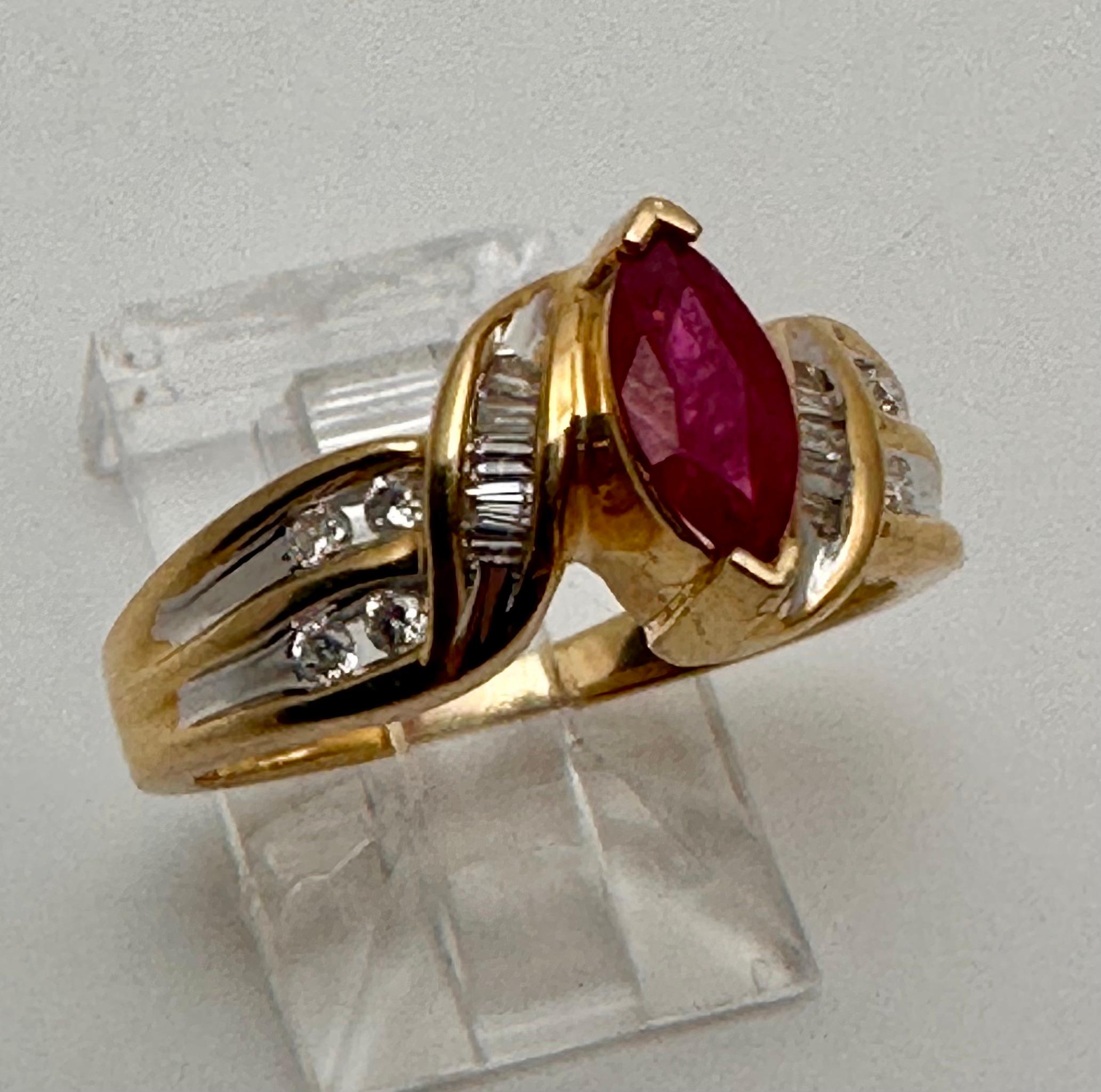 14k Yellow Gold approx. 4mm x 8mm Marquise Ruby Baguettes & Round Diamonds Ring Size 7.

This 14k yellow gold ring features a stunning marquise-shaped ruby as the main stone, surrounded by baguette and round diamonds that add a touch of elegance to