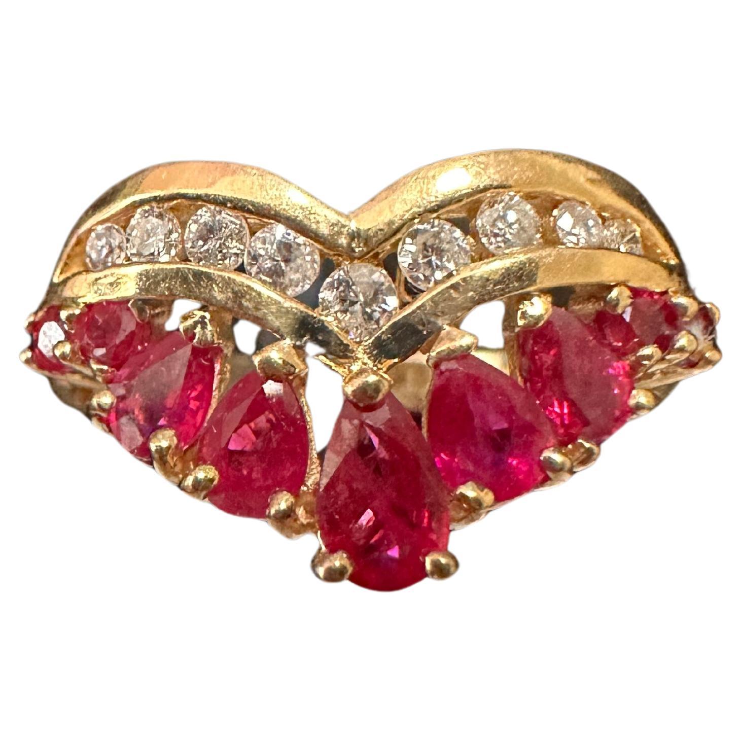 14k Yellow Gold ~ 5 Pear Shape + 2 Round Rubies ~ 9 Diamonds Ring Size 6 1/4

This stunning 14k yellow gold ring features five graduating pear-shaped + two round natural rubies, accompanied by 9 round diamonds, set in a prong and channel setting