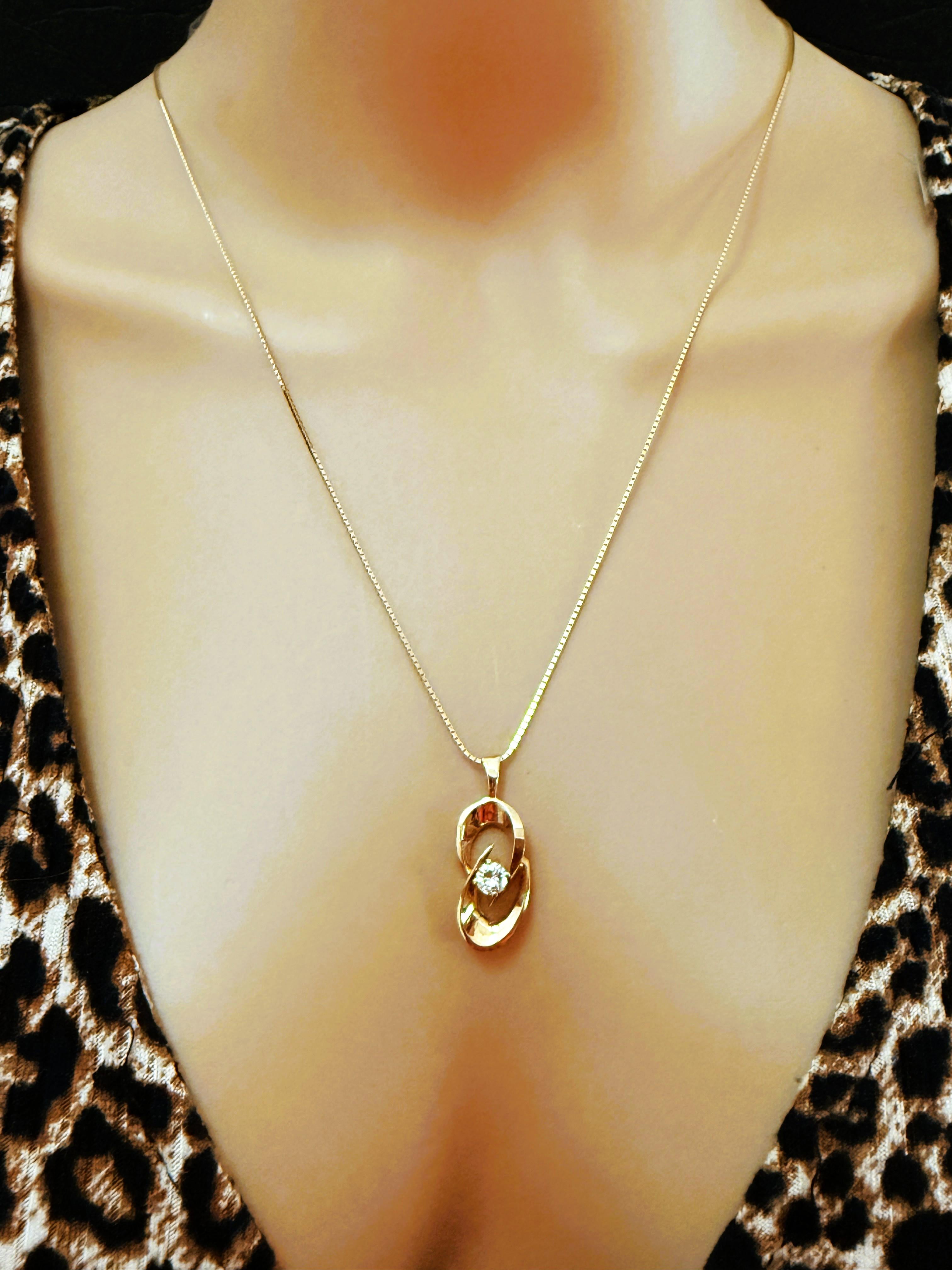 What a gorgeous and elegant necklace.  This pendant is just beautiful.  It has a .50 carat brilliant cut diamond as the centerpiece of the 14k yellow gold openwork pendant.  It is a quality diamond.  It is a larger pendant measuring 28 mm long and