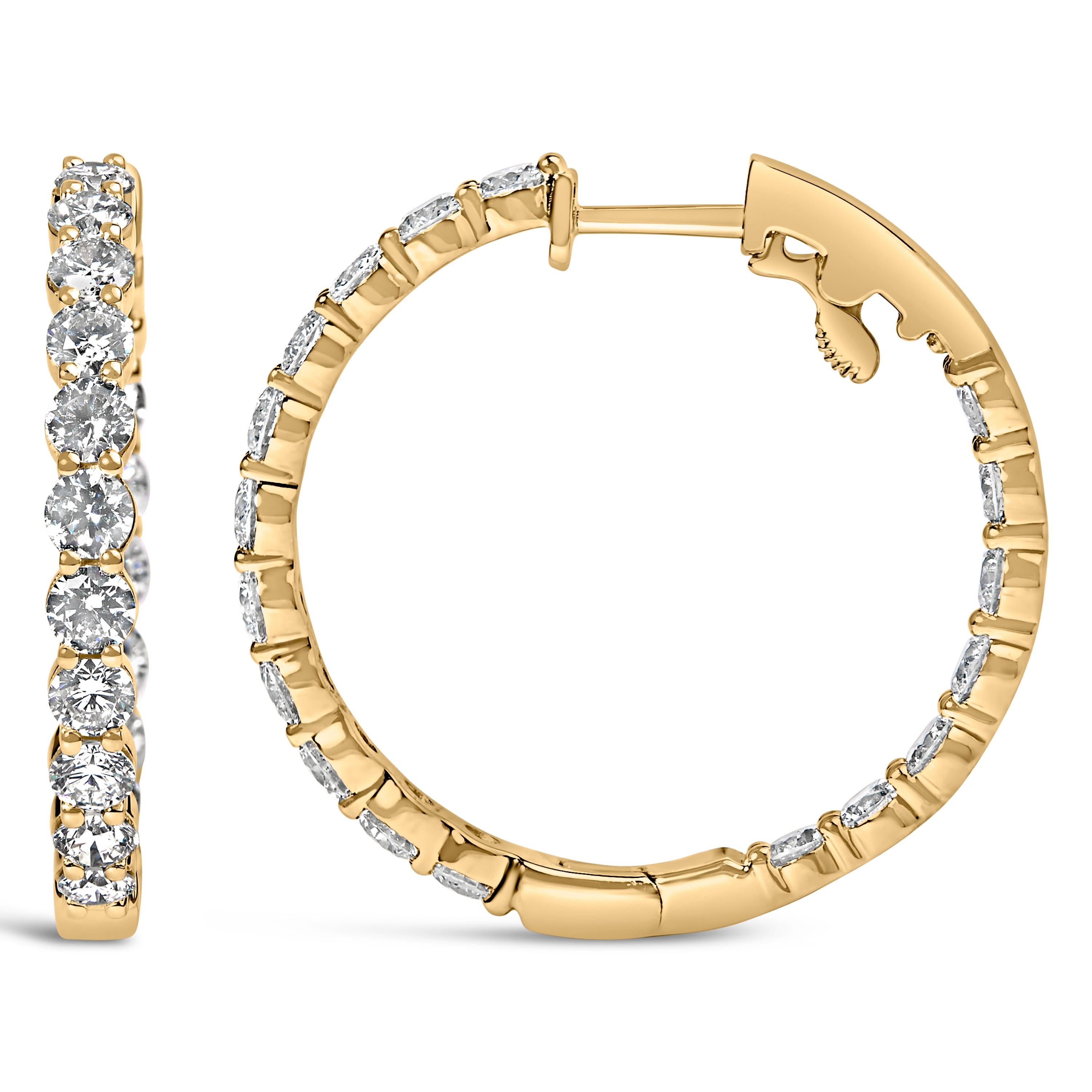 Bask in the glow of timeless elegance with these exquisite hoop earrings, meticulously crafted from 14K yellow gold. Adorned with natural brilliant round-cut diamonds, each earring embodies an enchanting dance of light, thanks to its shared prong