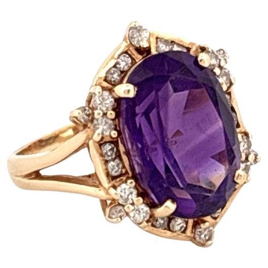 Crafted in the 1980s, this stunning cocktail ring is a radiant display of bold vintage glamour. At its center sits a vibrant 5.15-carat oval cut purple amethyst, prized for its rich, saturated hue and mesmerizing depth. The amethyst is framed by a