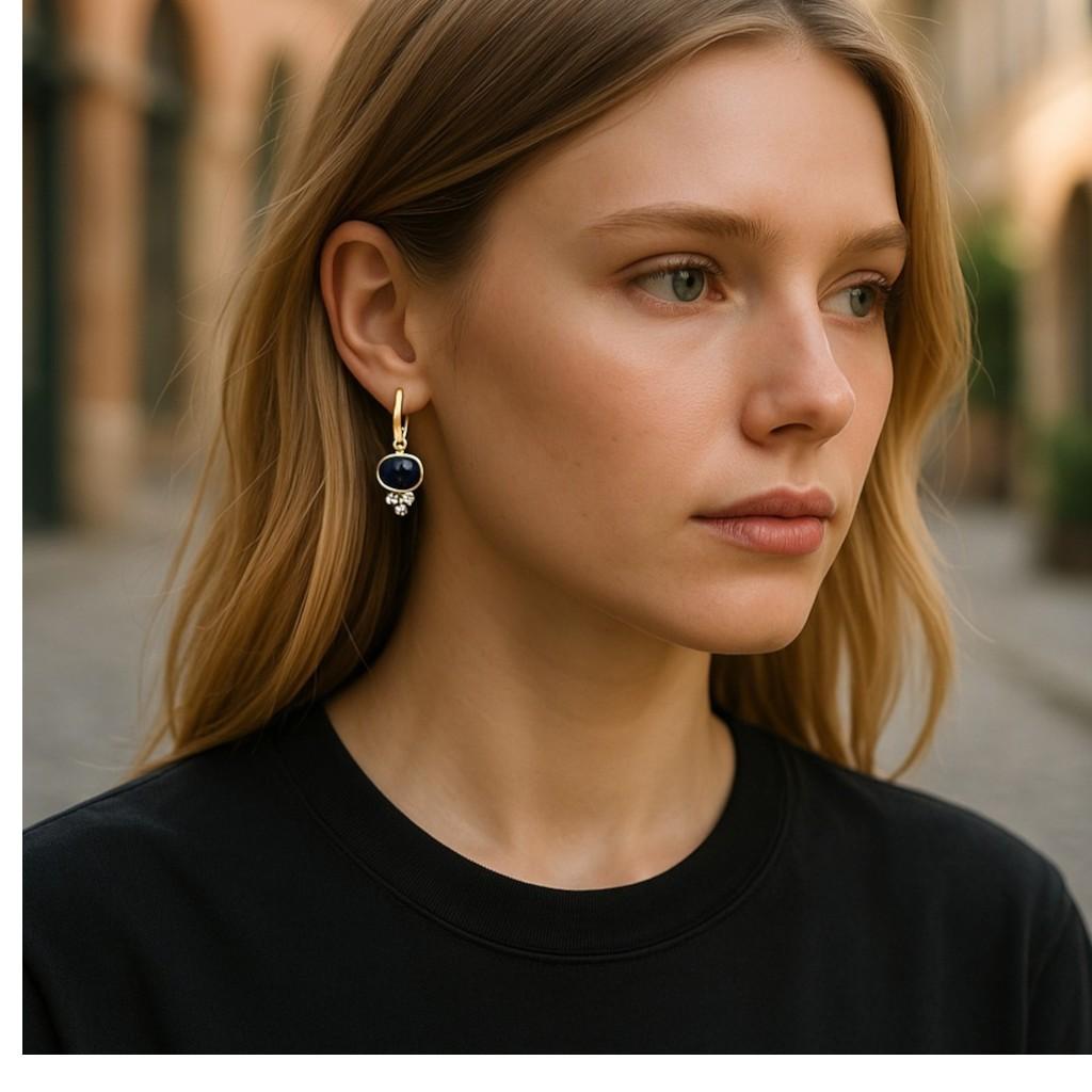 Discover the epitome of timeless refinement with these 14K Yellow Gold Lever Back Earrings, masterfully set with exquisite natural gemstones. Each earring showcases an exceptional oval cabochon sapphire, collectively weighing an impressive 5.45