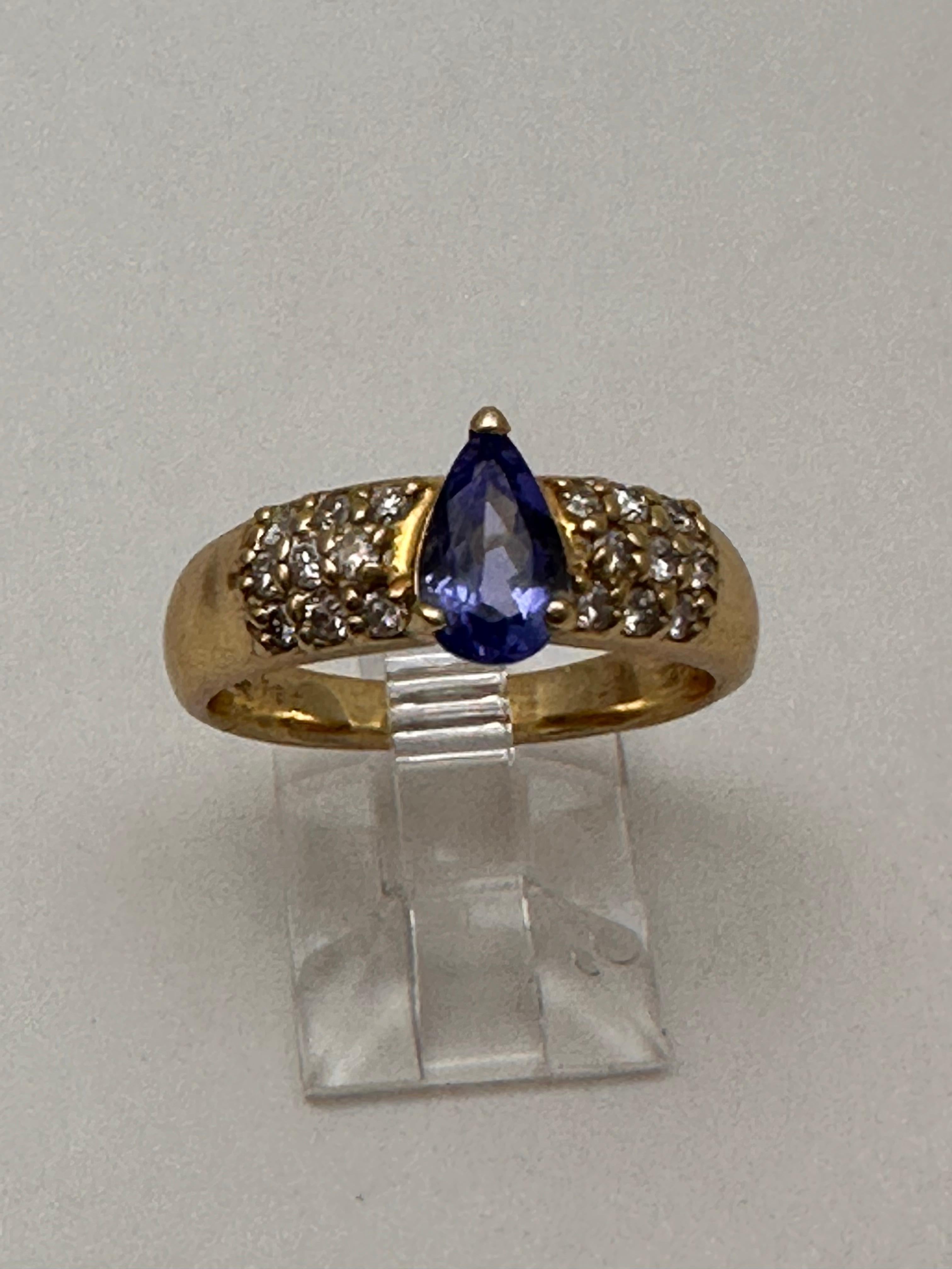 14k Yellow Gold approx. 5.5mm x 8.5mm Pear Shape Tanzanite 
18 side Diamonds 
Ring Size 7 1/2

Tanzanite 

Tanzanite changes colors when it is viewed from different directions. This shifting of colors has been said to facilitate raising
