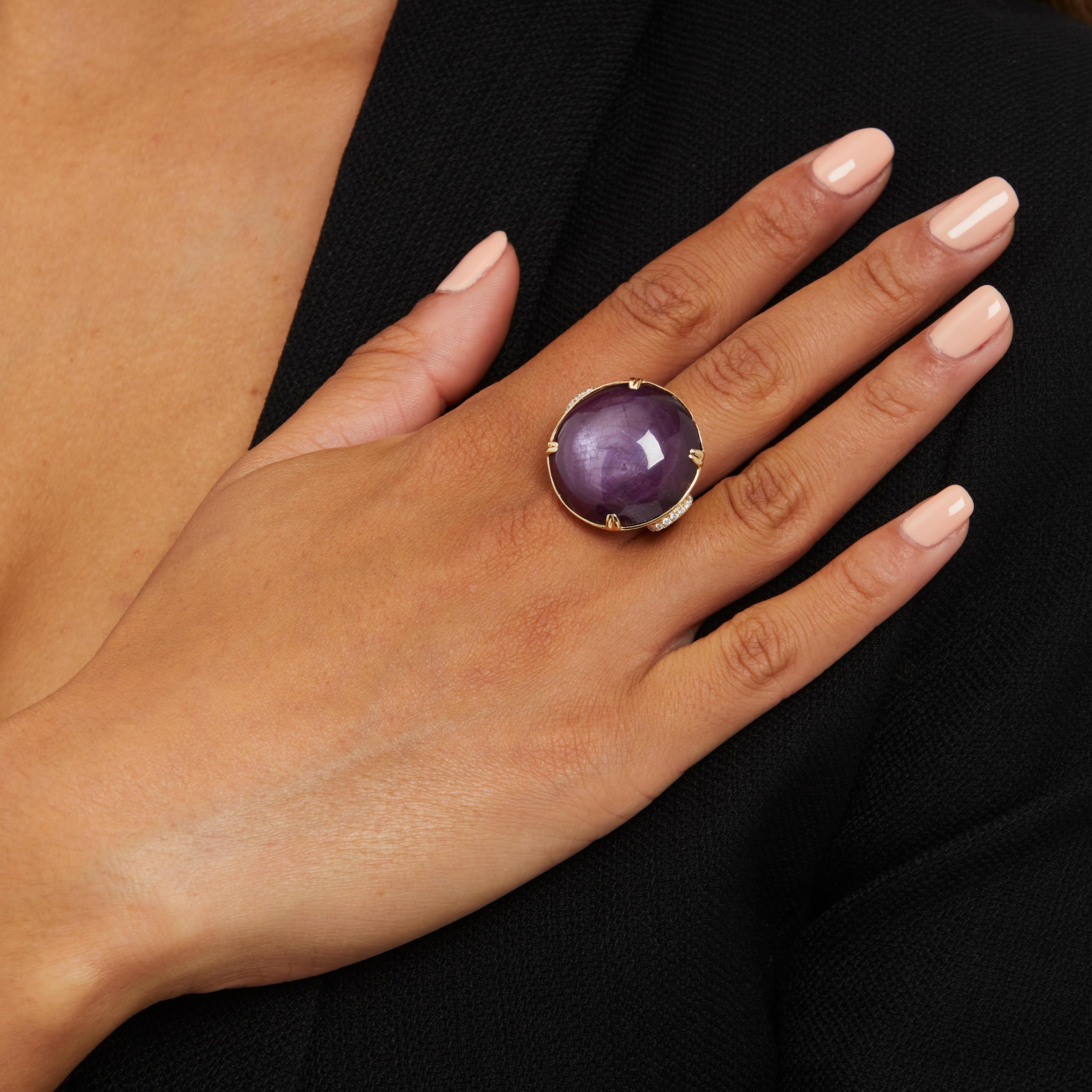Beautiful Ring With Star Ruby and Diamonds Set in 14k Yellow Gold.
Size 7.
Features a 56.81 Carat Cabochon-Cut Star Ruby.
Accented by ~0.40 Carats of Round Diamonds.
Total Weight: 17.3 grams.
Featured in Bonhams California Jewels Auction on May 5,