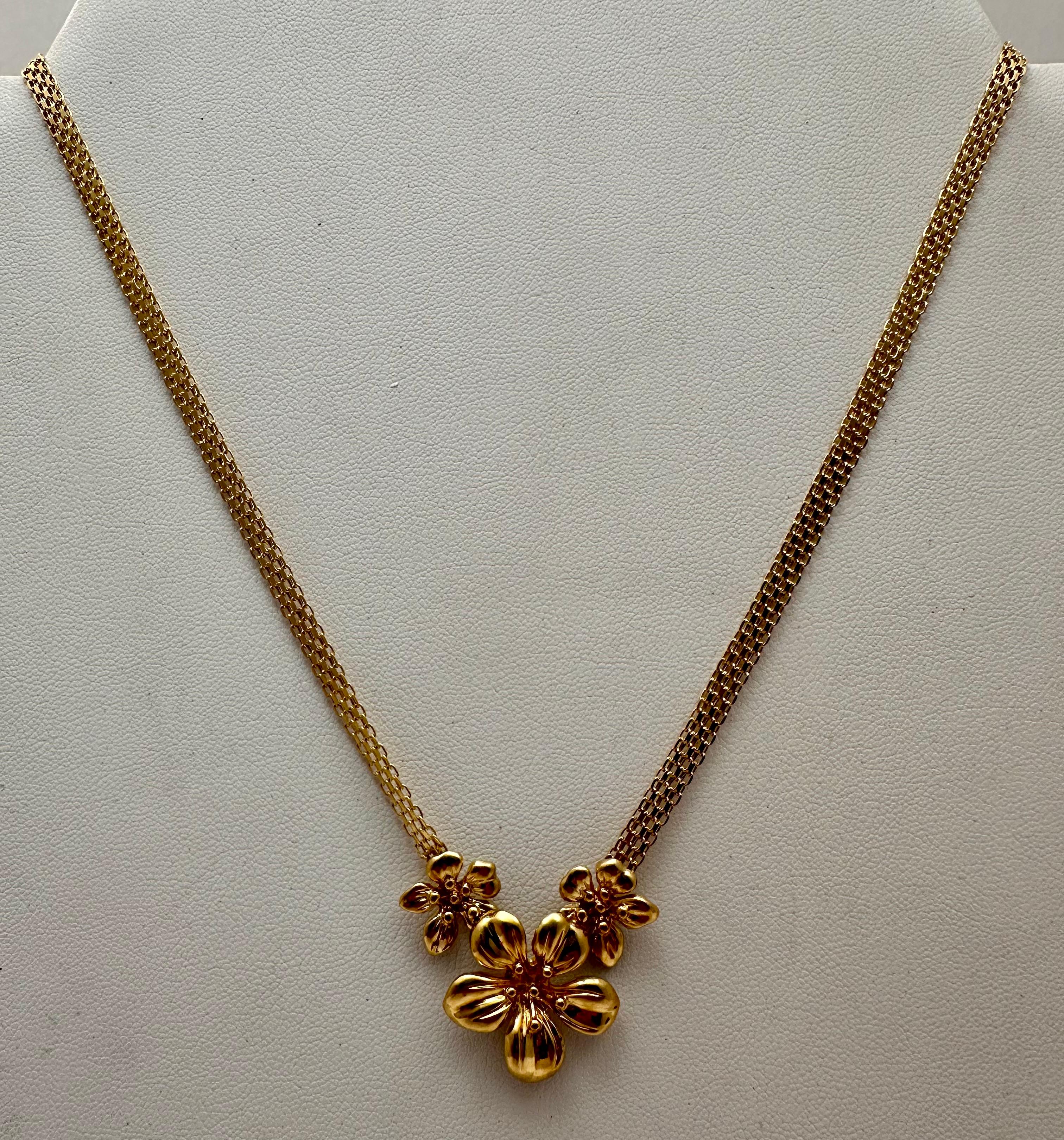 Feel like a queen with this stunning 14 karat yellow gold choker necklace. Featuring an exquisite floral design, this piece is perfect for formal occasions or to add a touch of glamour to your everyday wardrobe. The wide 5mm chain sits comfortably
