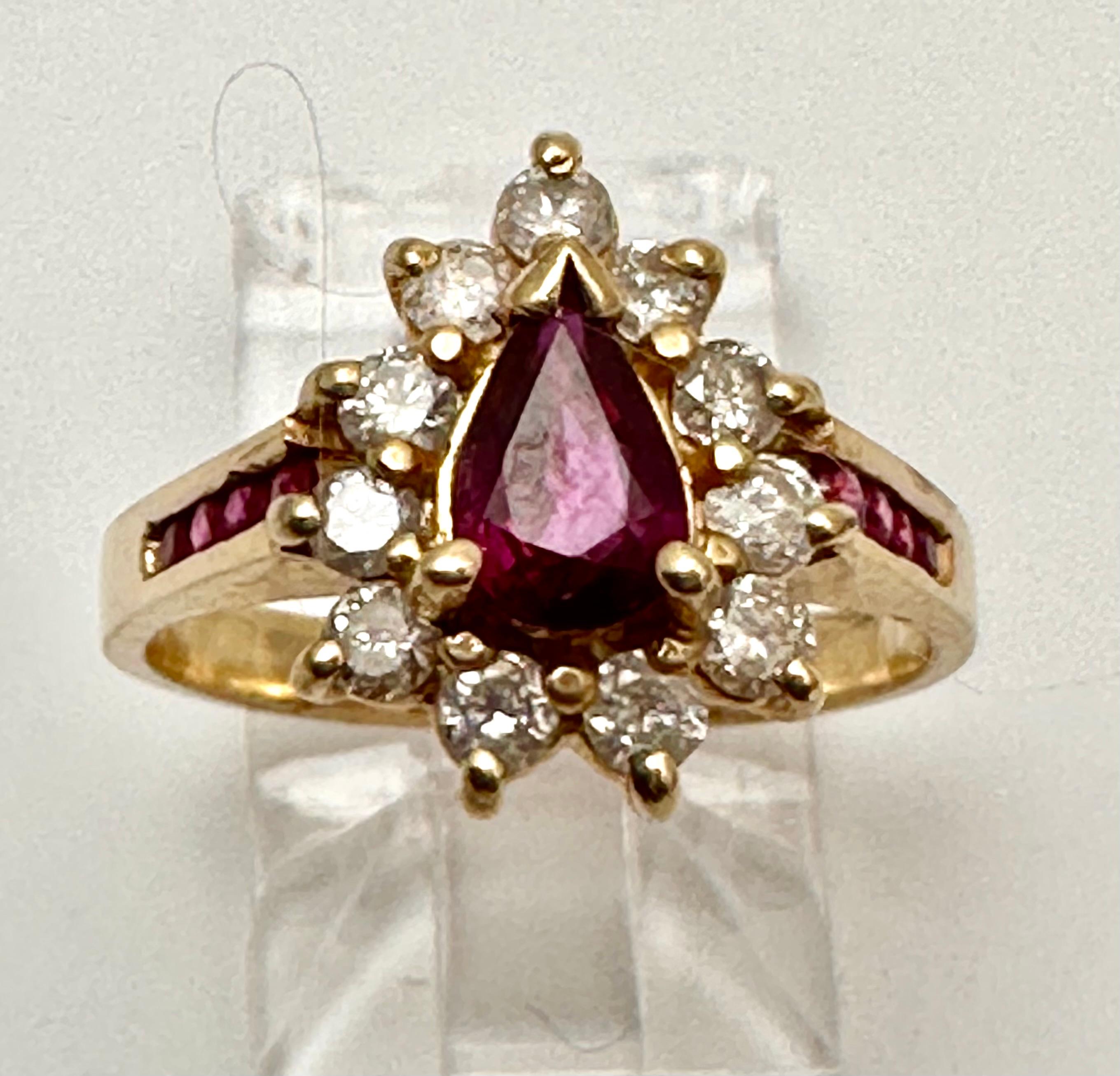 14k Yellow Gold approx. 5mm x 7mm Pear Shape Ruby with 11 surrounding approx. 2.5 - 3mm Round Diamonds. Eight round channel set rubies, 4 on each side.
Ring Size 6 1/2

The ruby is known as a protective stone that can bring happiness and passion