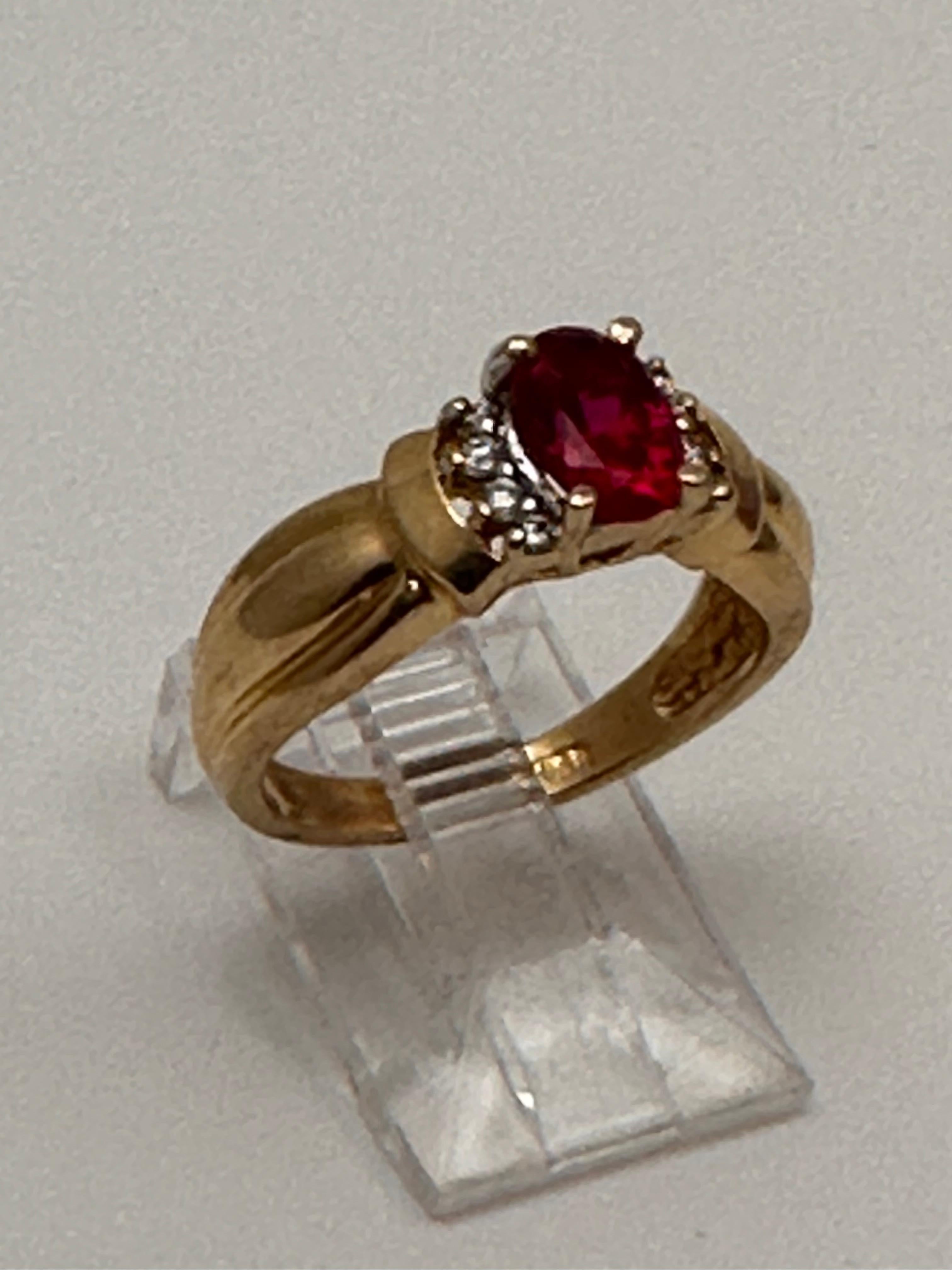 14k Yellow Gold ~ 5mm x 7mmm Oval Synthetic Ruby and Diamond Ring Size 6 1/4 In New Condition For Sale In Las Vegas, NV