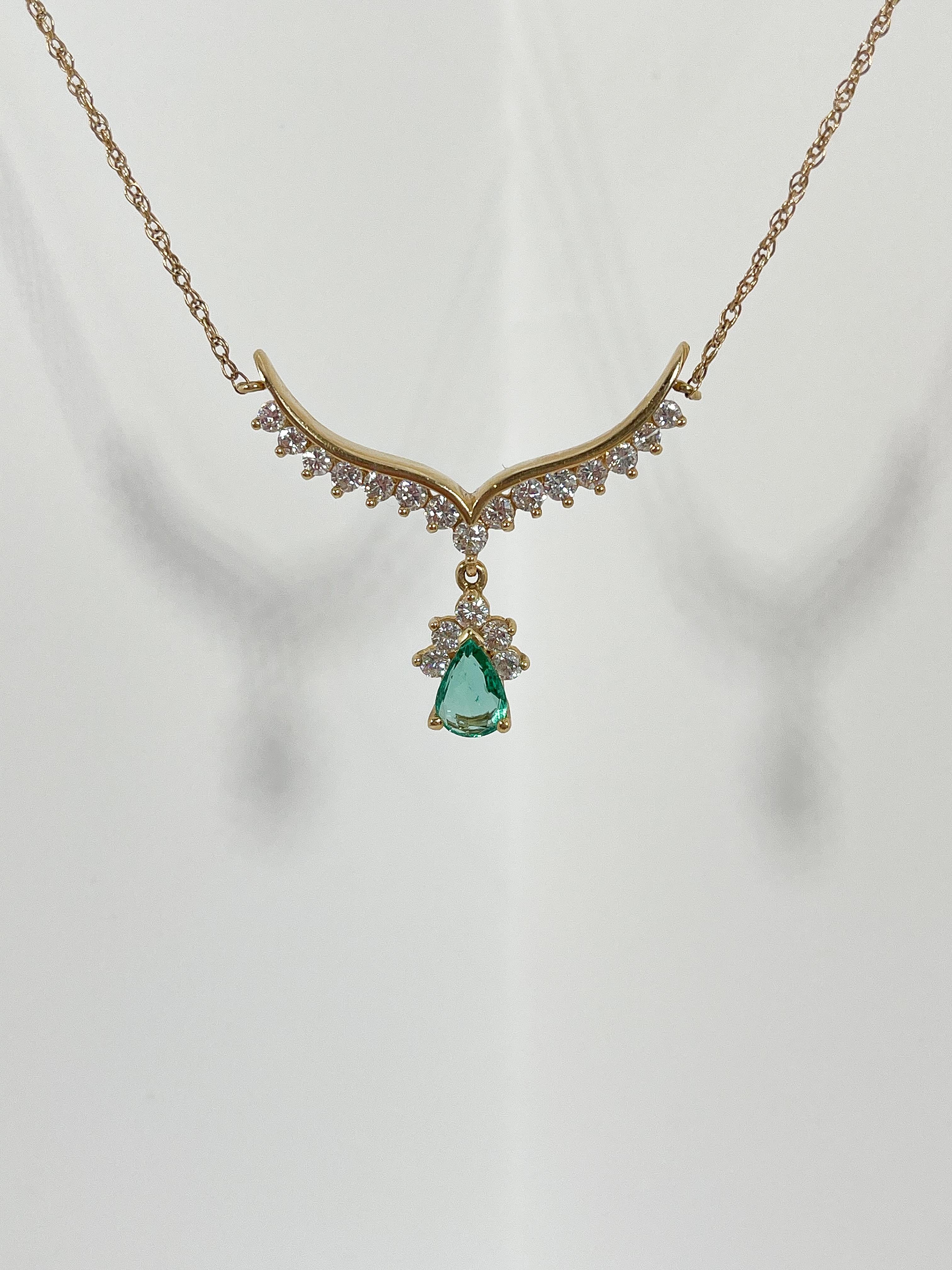 14k yellow gold .65 CT pear emerald and .60 CTW diamond necklace. Necklace measures 18 inches long, diamond cut cable chain, all diamonds are round, has a lobster clasp to open and close, and it has a total weight of 3.9 grams. 