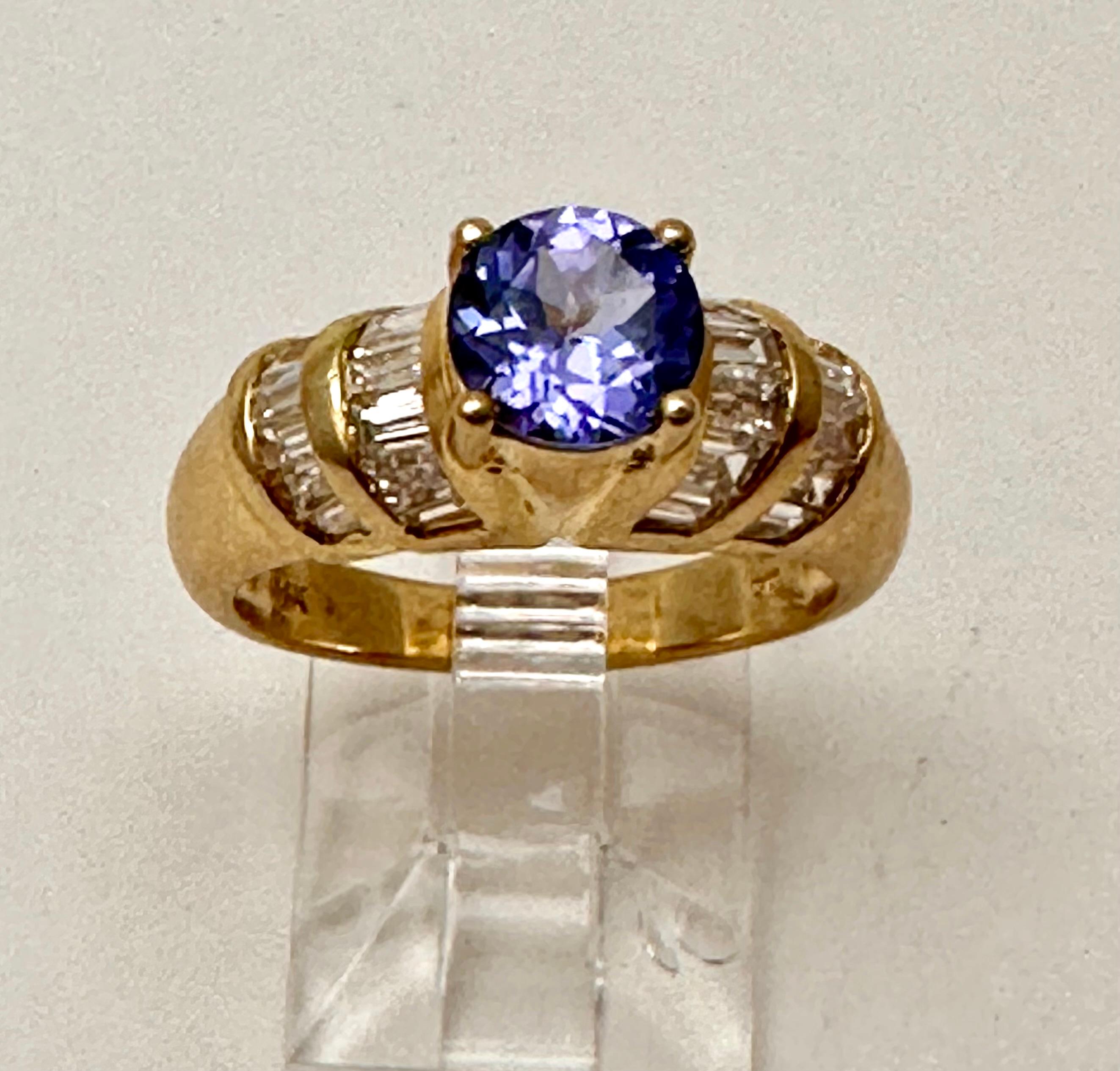 14k Yellow Gold 6.5mm Round Tanzanite Diamond Ring Size 6.5 
Two Rows of Baguettes on each side...beautiful ring 

Tanzanite 

Tanzanite changes colors when it is viewed from different directions. This shifting of colors has been said to facilitate