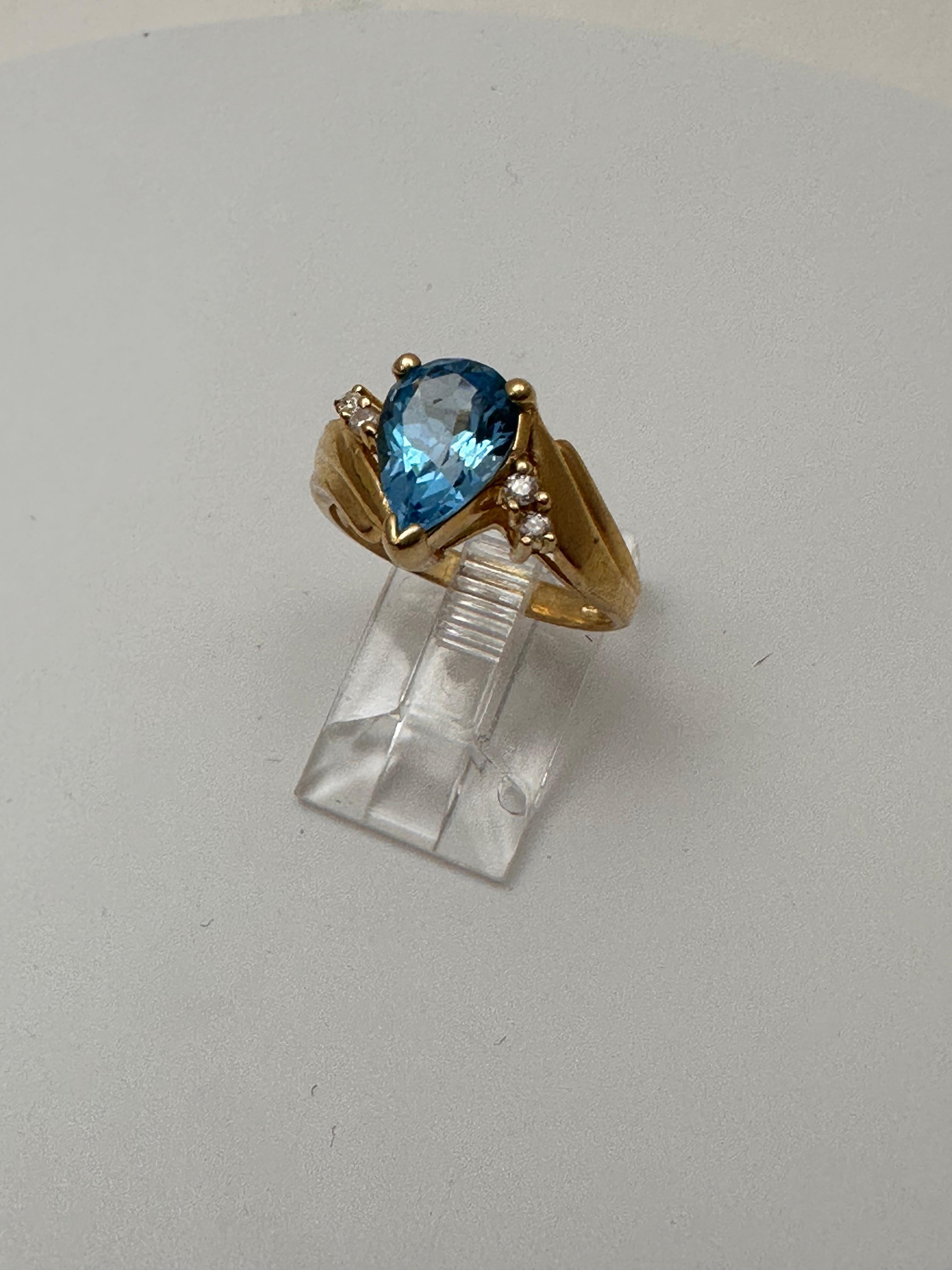 Modern 14k Yellow Gold 6.7mm x 10mm Pear Blue Topaz 4 Round Diamond Ring Size 6 1/2 For Sale