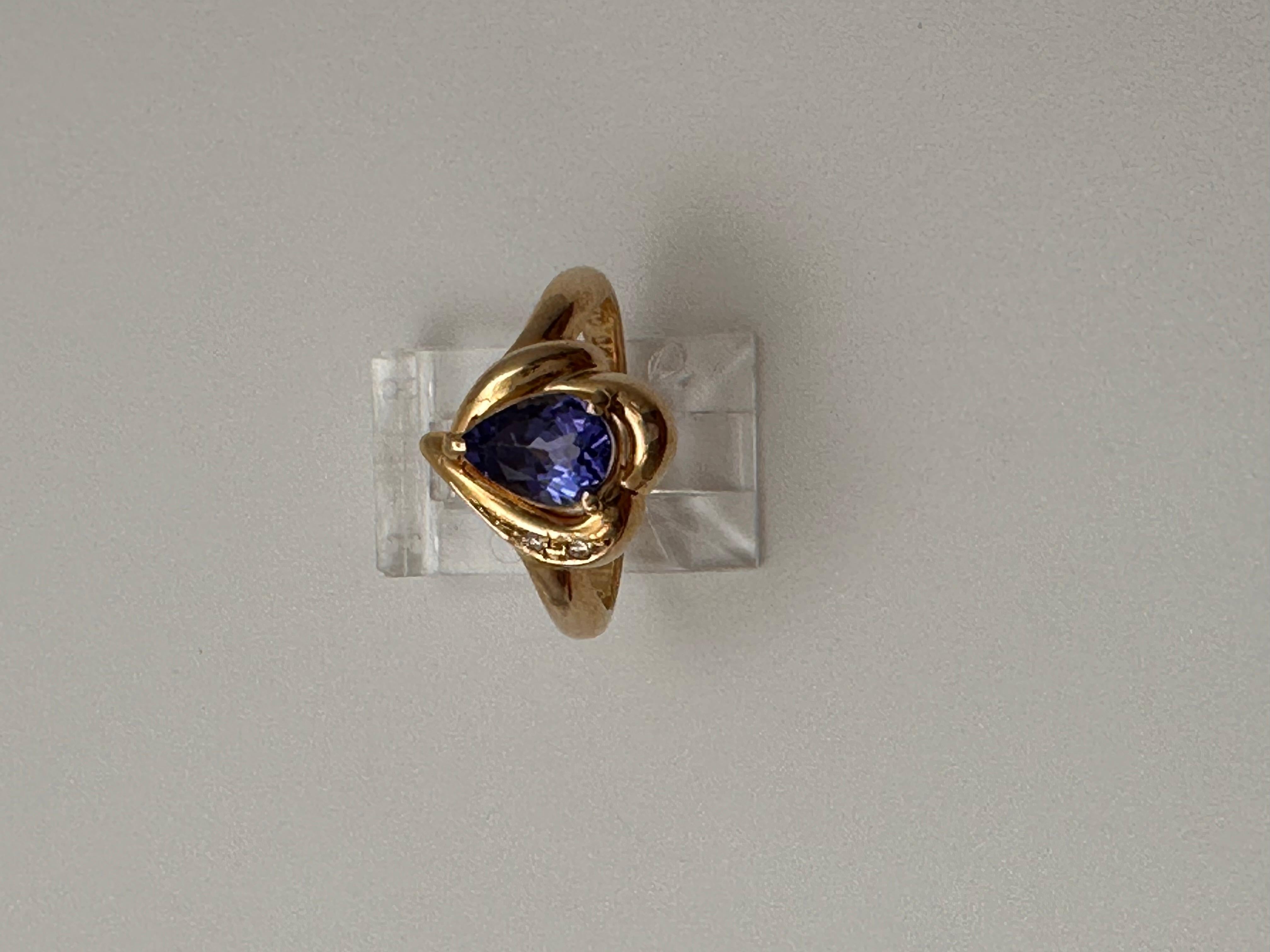14k Yellow Gold approx. 6mm x 8mm Pear Tanzanite with 2 Side Diamonds 
Ring Size 6 1/2

Tanzanite 

Tanzanite changes colors when it is viewed from different directions. This shifting of colors has been said to facilitate raising consciousness. It