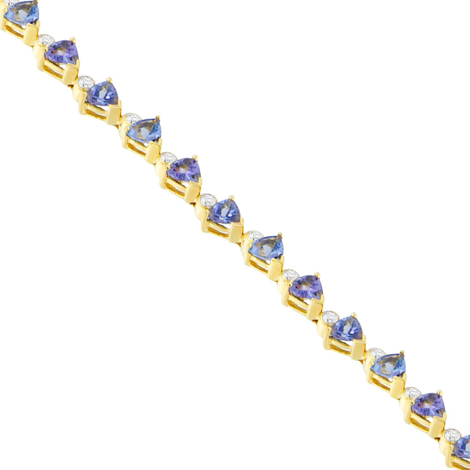 Subtle and elegance abounds in this chic fashion bracelet. Crafted of 14 karats yellow gold, alternating geometric patterns are set with dazzling round cut diamonds. Further, the setting with precious tanzanite gemstones in a triangular shape lends