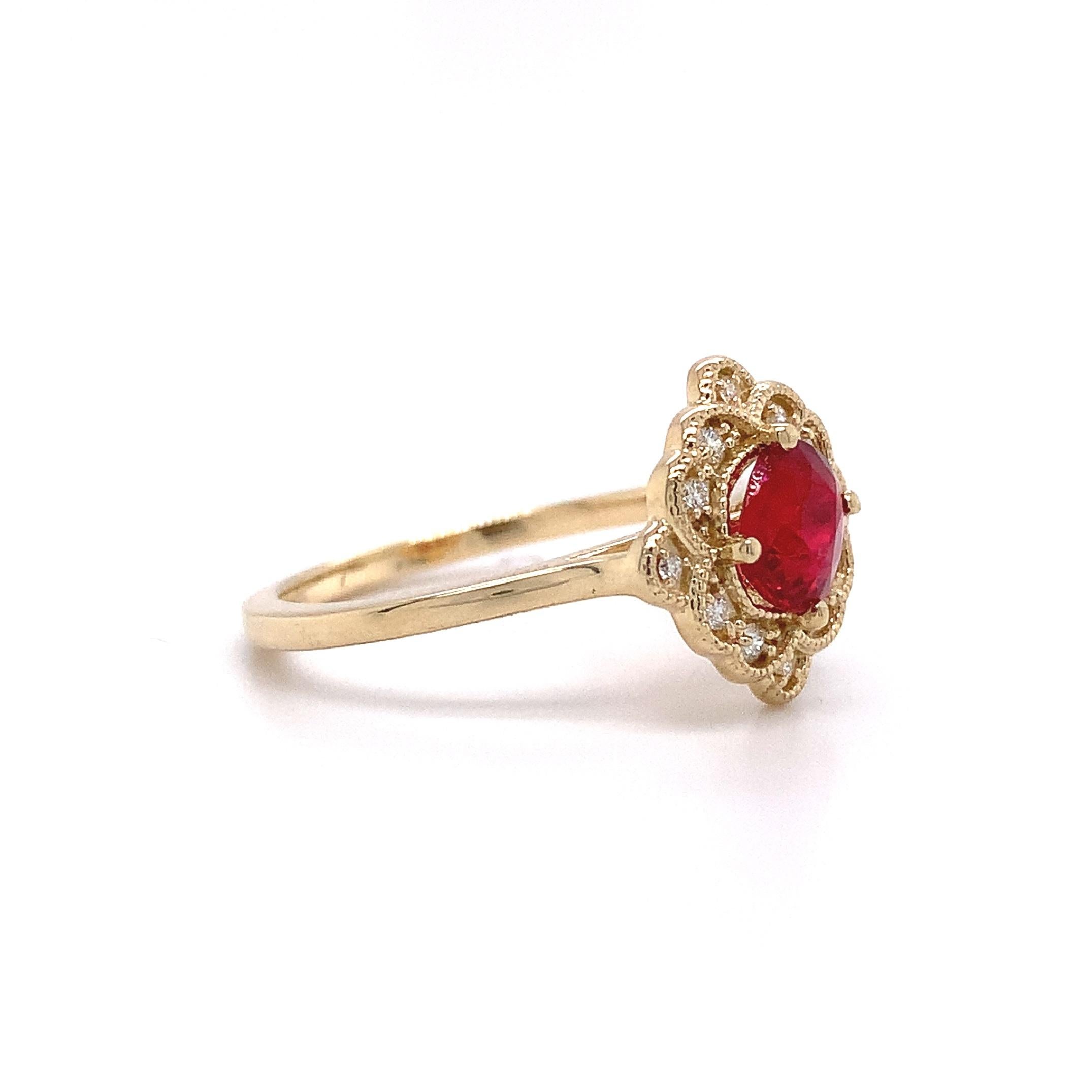 14K yellow gold diamond ring featuring a Jedi red spinel. The red spinel weighs .77 cts. It is Burmese and no heat. The spinel is cushion cut and measures about 6.2mm x 5.75mm. There is a small chip. There are 12 small round diamond accents