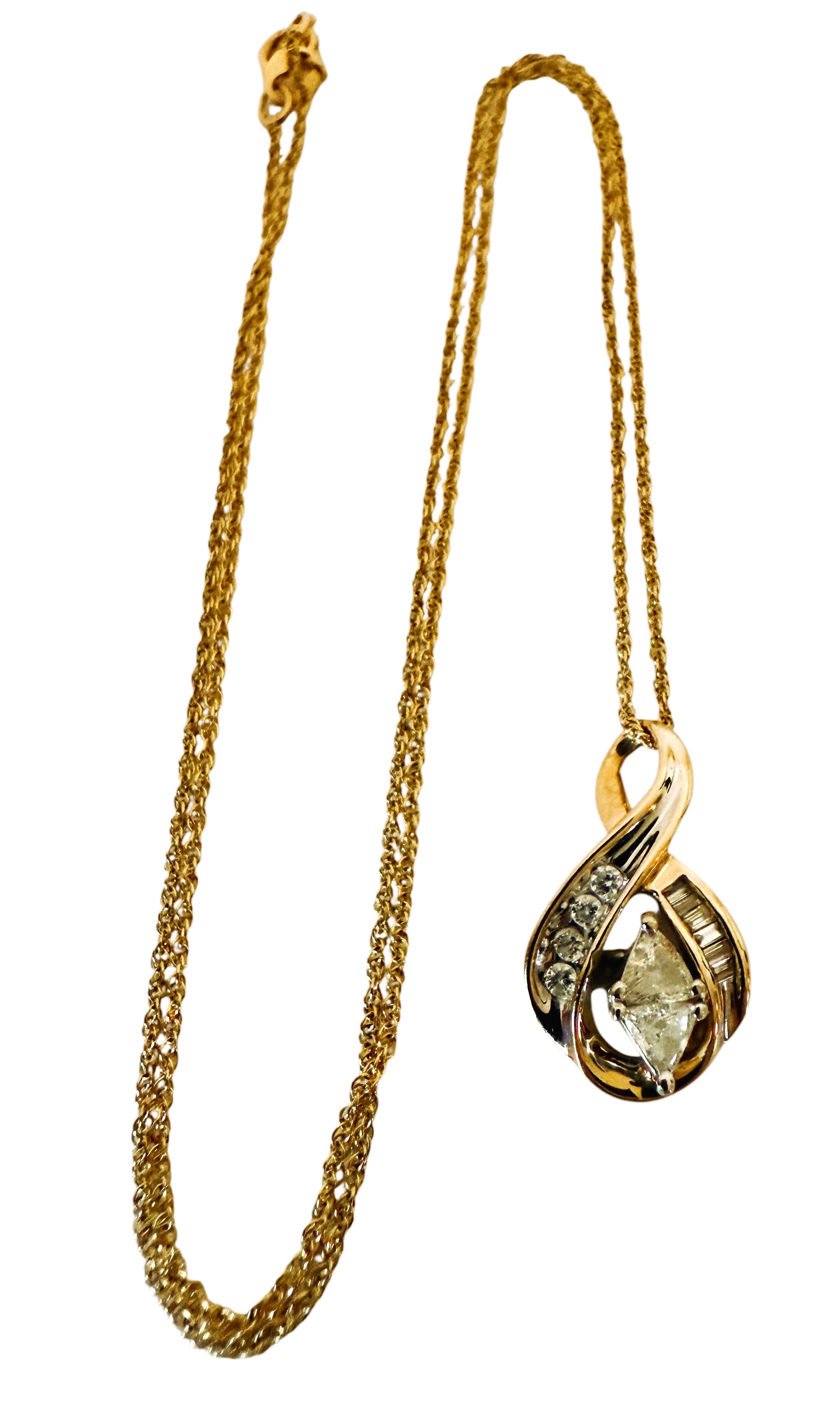 Ce collier est magnifique.  Il s'agit d'un produit d'occasion en excellent état.  Il a été très bien entretenu.  Le pendentif comporte 2 diamants de taille trillion, 4 diamants baguettes et 4 diamants de taille brillant d'une valeur totale de 0,80