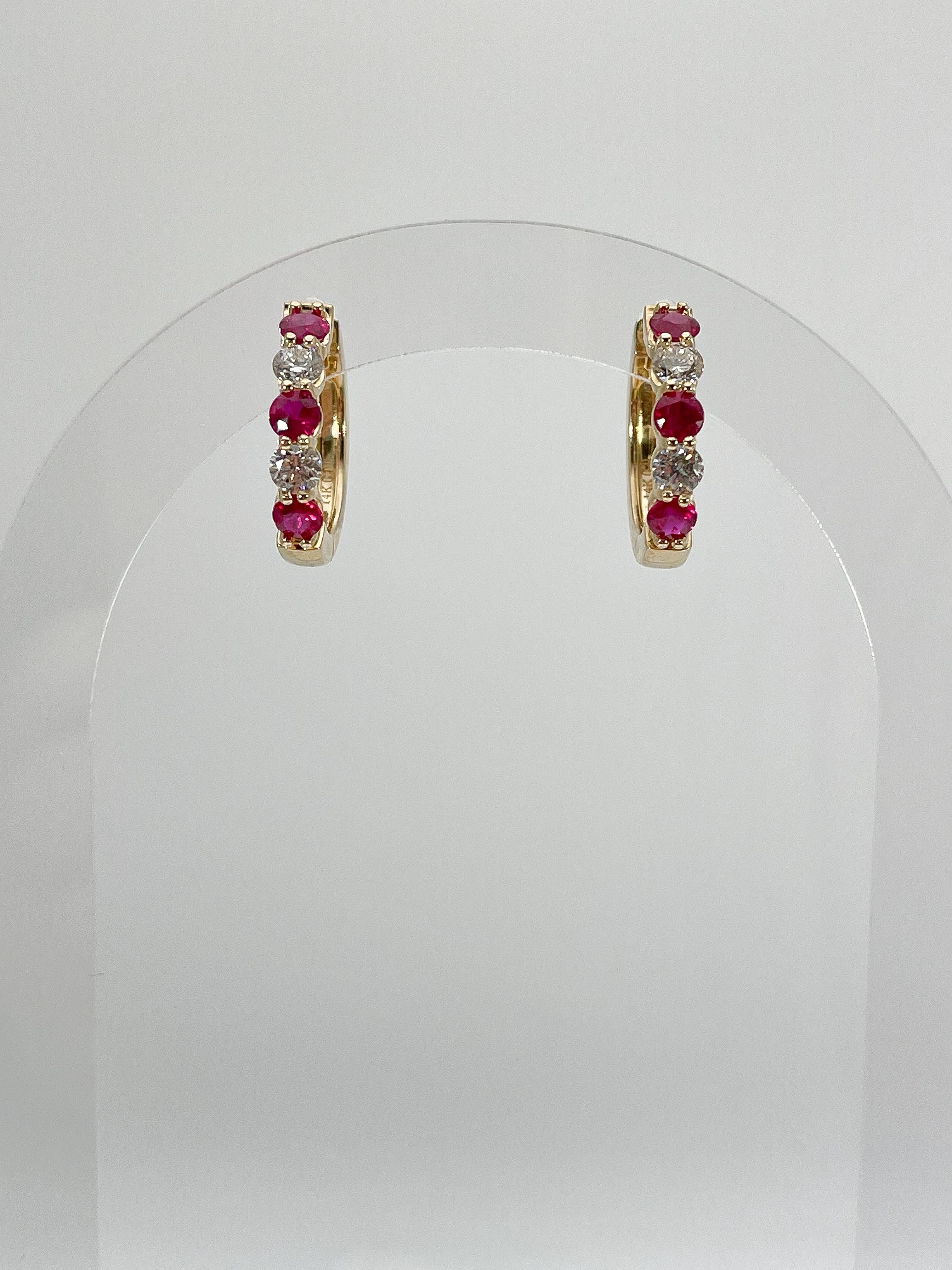 14k yellow gold .84 CTW diamond and 1.54 CTW Ruby Hoops. The stones in these earrings are all round, the measurements are 19.6 x 20, and they have a total weight of 6.95 grams.