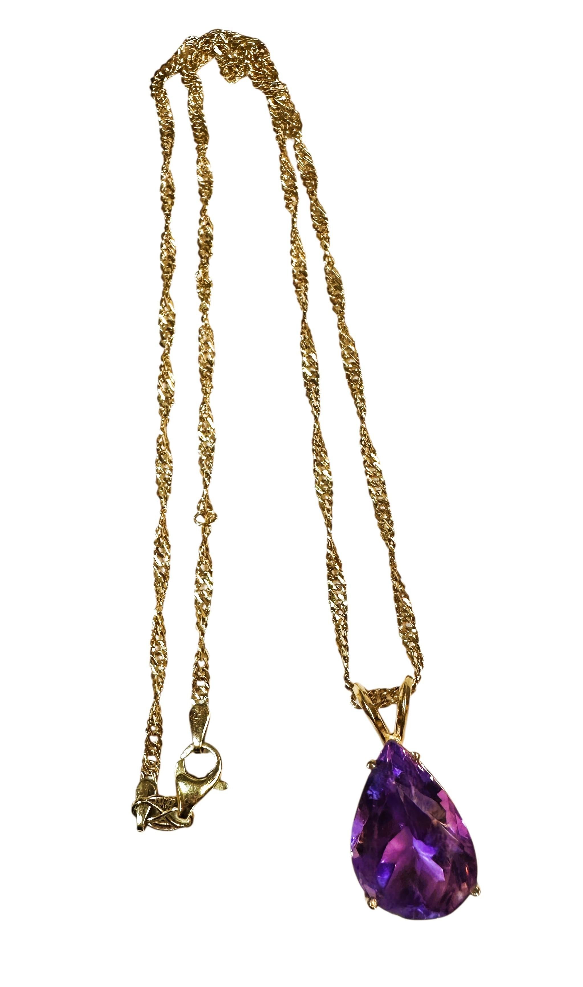 This is a beautiful necklace.  It has a pear cut amethyst stone that measures 16 x 12 mm and totals 9 carats.  It is on a beautiful 14k Yellow Gold Singapore chain that is 16 inches long.  The pendant is not marked but tests as 14k gold and the