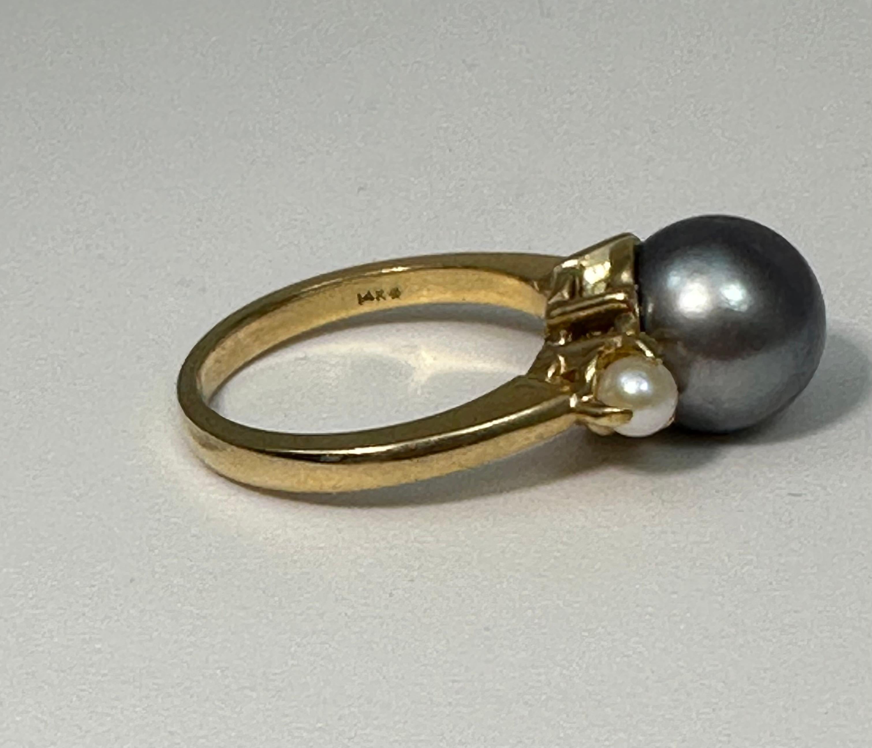 14k Yellow Gold ~ 9.5mm Gray Pearl ~ 2 ~ 4mm Side White Pearls ~ Ring ~ Size 6

Pearls are dainty, pale, shiny, round, and precious objects that effortlessly steal our interest. Since ancient times, pearls linger in our imagination and beliefs. To