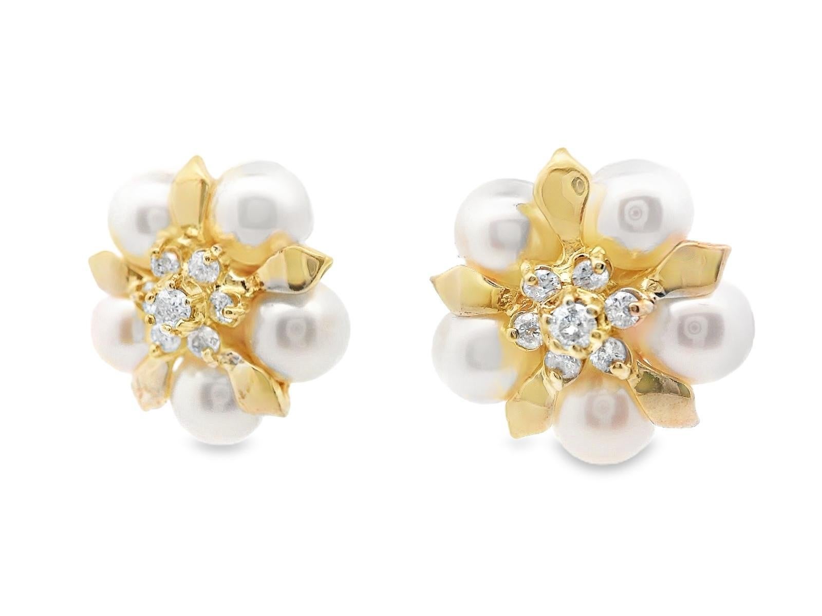 This lovely pair of earrings are made in 14k yellow gold with both sparkly diamonds and white pearls. These stud earrings feature diamond center stones that are surrounded by a boarder of 5 pearls, with golden flower petals between the pearls. The
