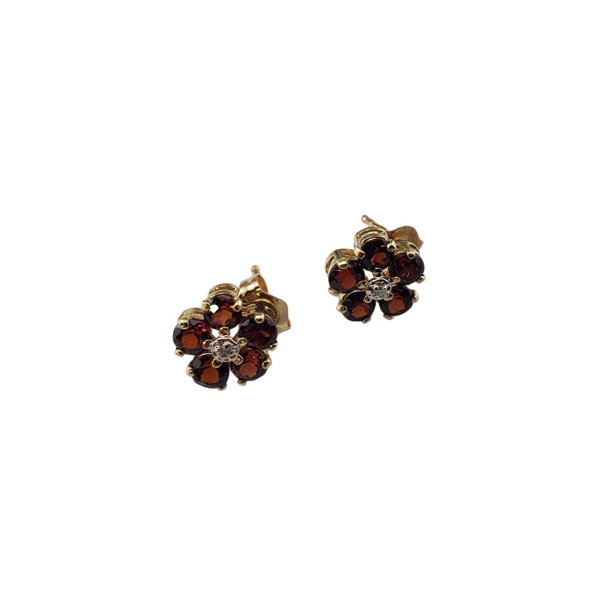 Vintage 14K Yellow Gold Almandine Garnet and Diamond Earrings-

These stunning earrings each feature five round almandine garnets and two round one round single cut diamond set in classic 14K yellow gold.  Push back closures.

Approximate total
