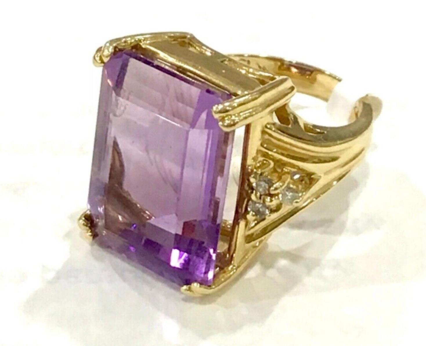 14k Yellow Gold Amethyst and Diamond Ring. 9.8 dwts. The dimensions of the amethyst baguette are approximately 19 mm length x 14 mm width x 6 mm depth. The ring has six round single cut diamonds. Marked 14k and makers brand.