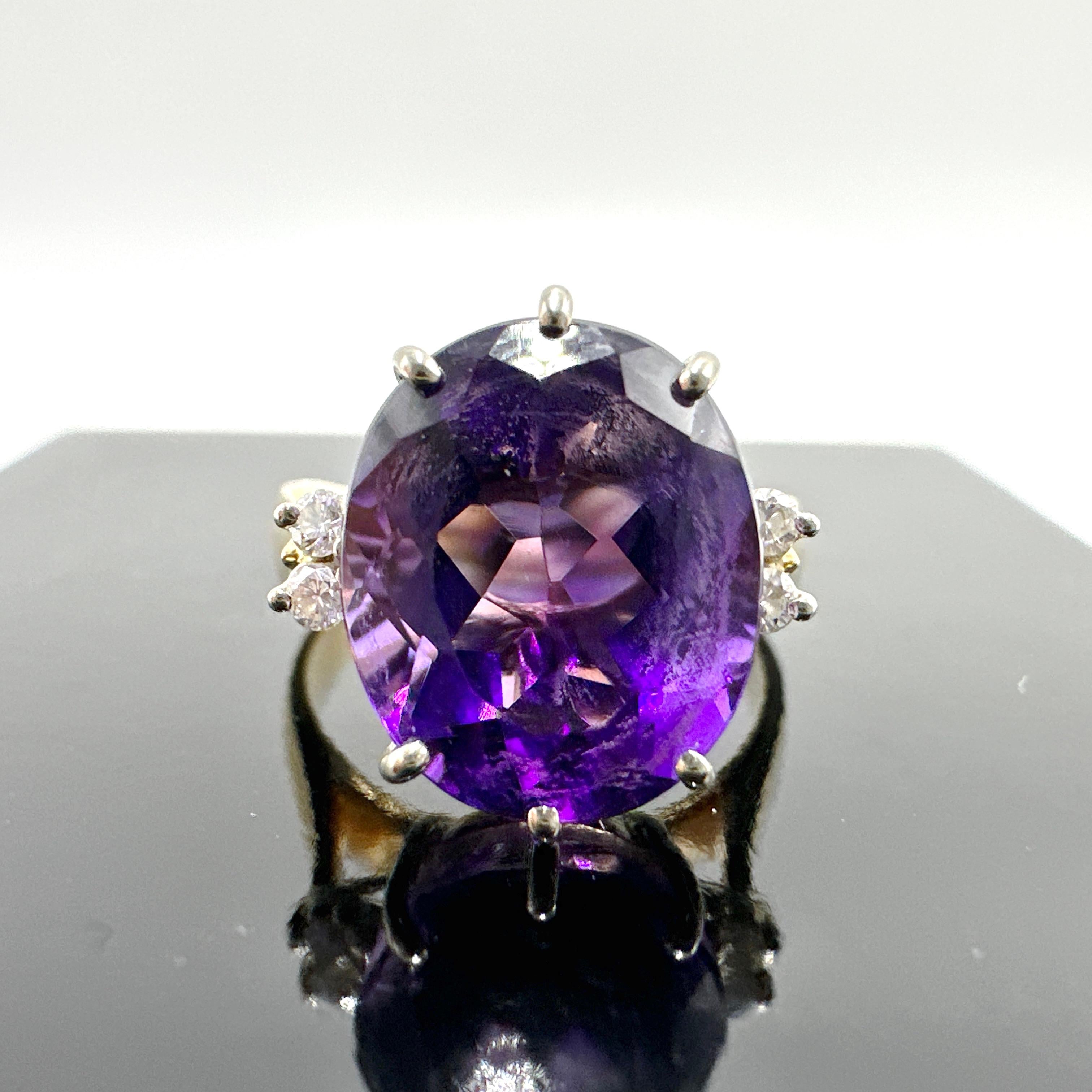 Here is a beautiful 14k Yellow Gold Amethyst and Natural Diamond Cocktail Ring.

This ring features a 4.79ct oval cut amethyst quartz measuring 12.00mm x 10.00mm x 7.15mm. Amethyst is very lightly included with medium tone, purple hue, moderately
