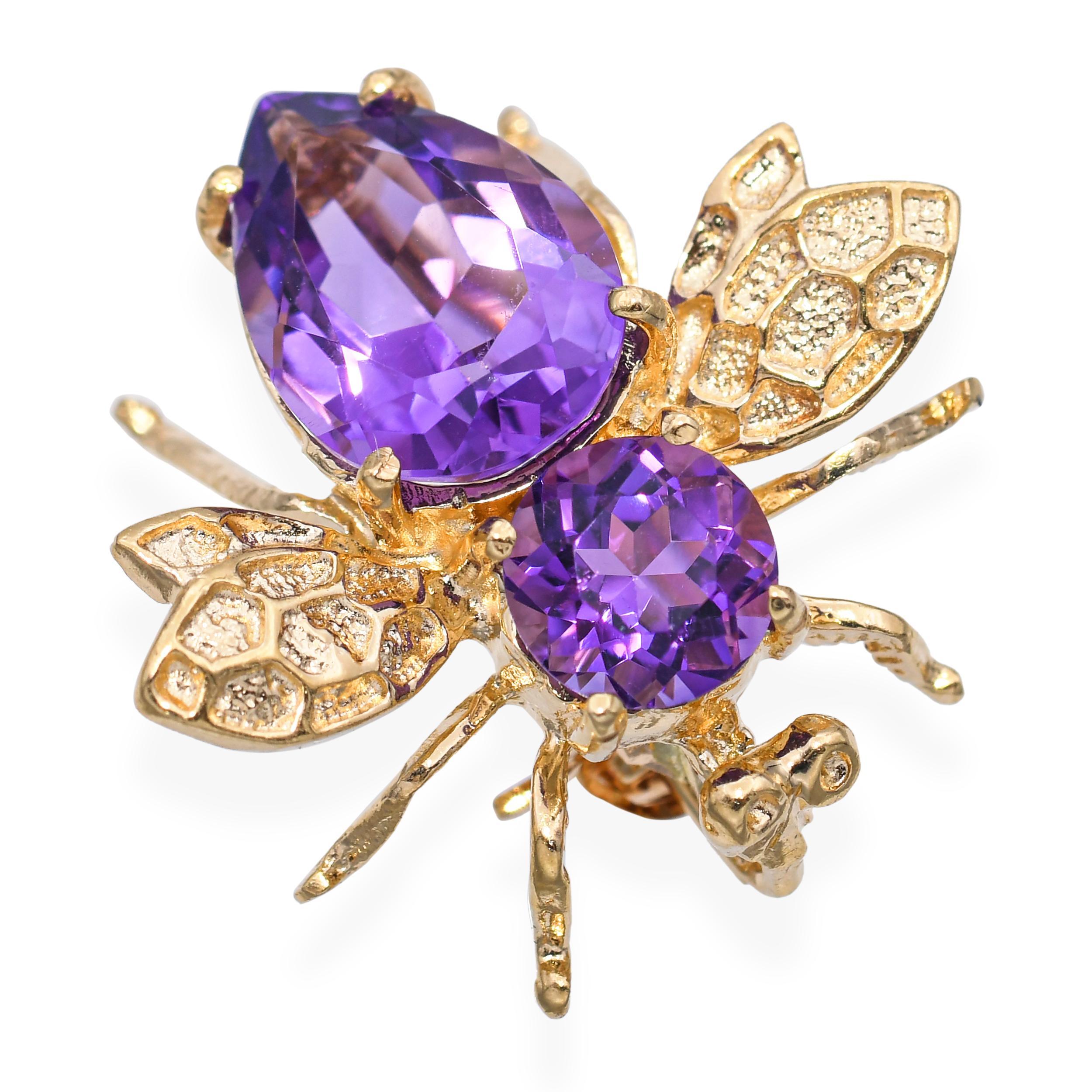 This enchanting vintage bumblebee brooch is crafted in 14k yellow gold and set with vibrant amethyst cabochons that form its body and head. The rich purple hues of the amethyst contrast beautifully with the warm gold tones, while intricate detailing