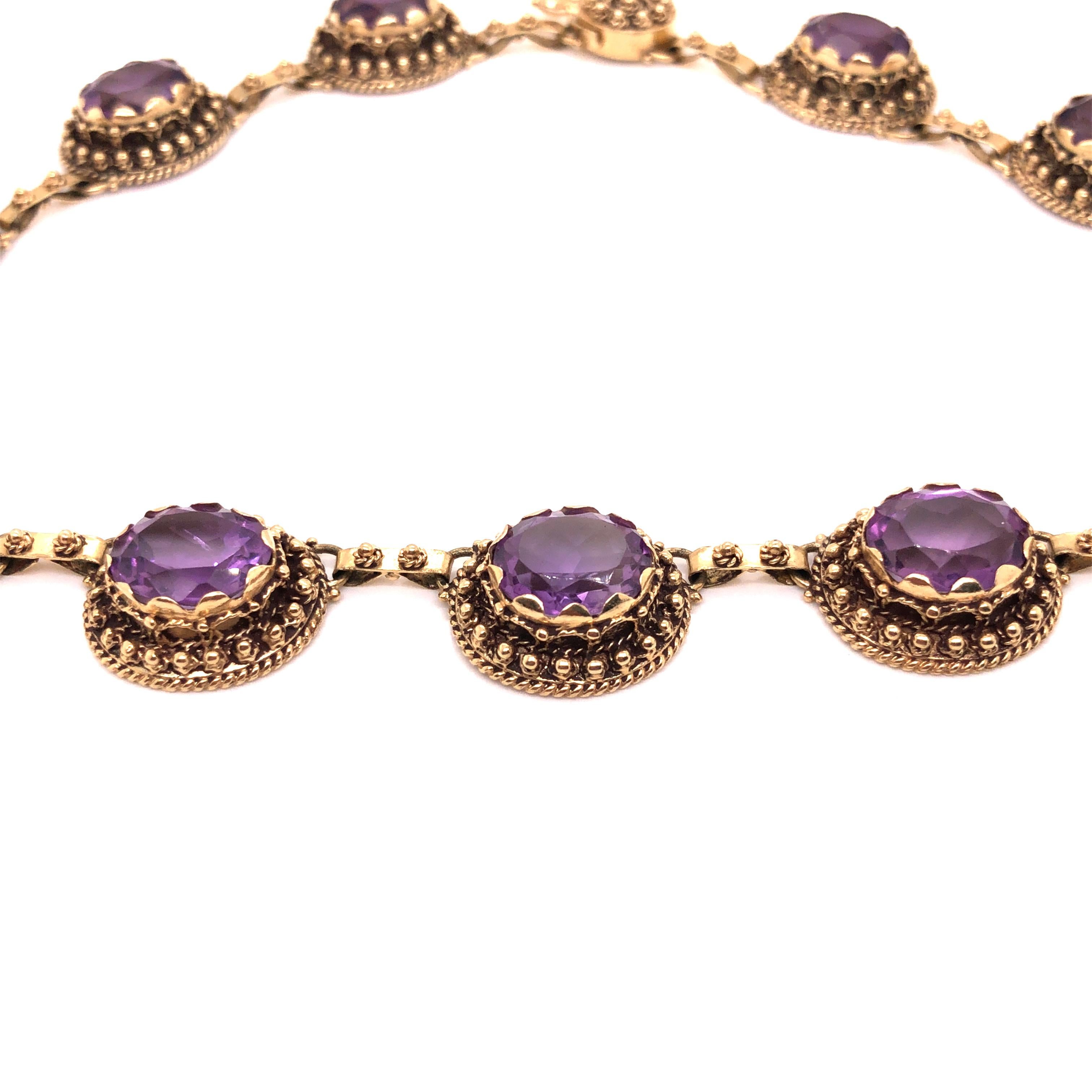 A vintage 14K yellow gold necklace consisting of 12 oval-cut amethyst measuring approximately 10mm x 12mm each.

Stone: Amethyst

Metal: 14K Yellow Gold

Size: 14.5