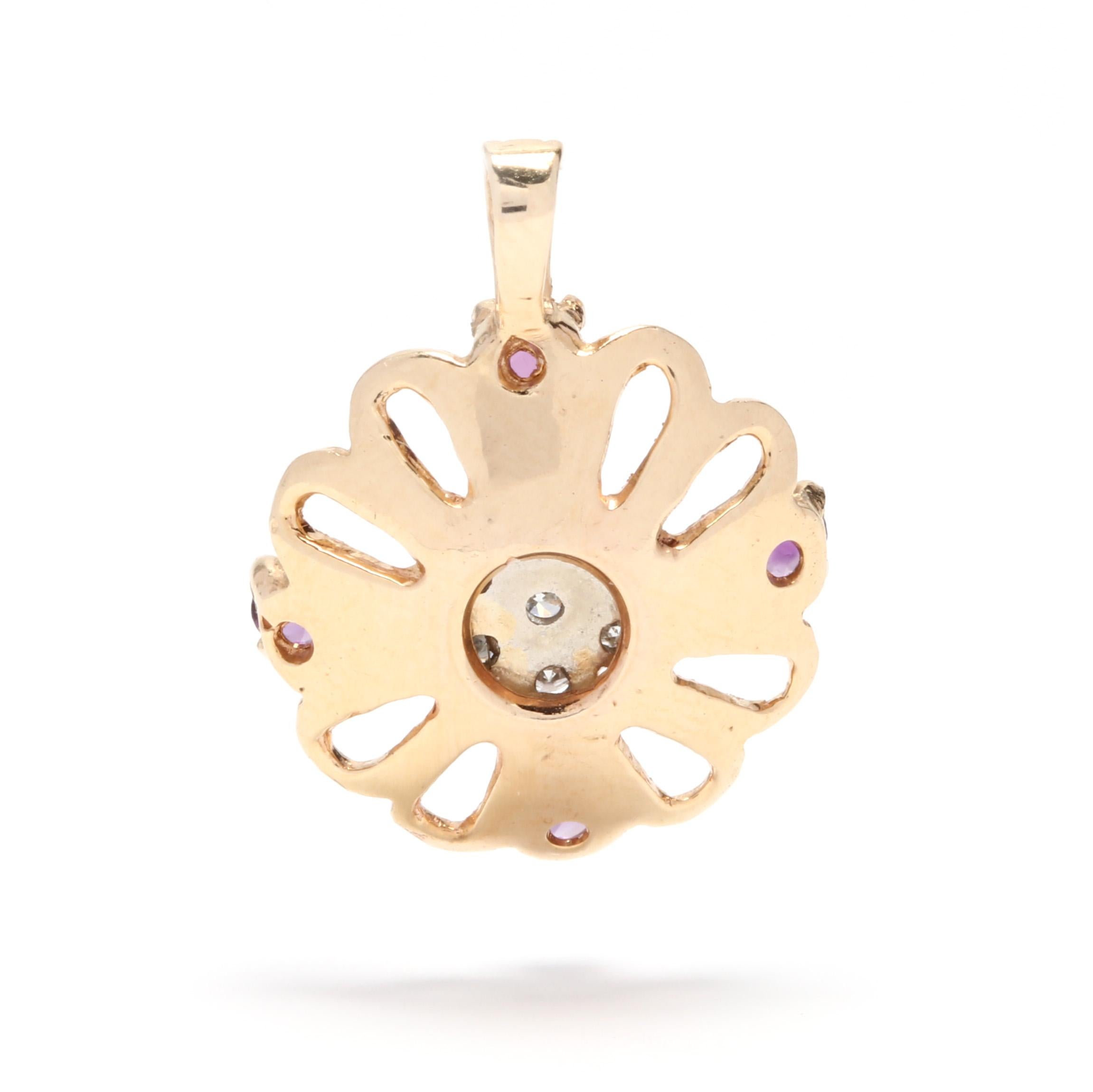 A 14 karat yellow gold, amethyst and diamond flower charm / pendant. This charm features an open flower motif with four prong set, round cut amethysts and a center cluster of full cut round diamonds weighing approximately .16 total