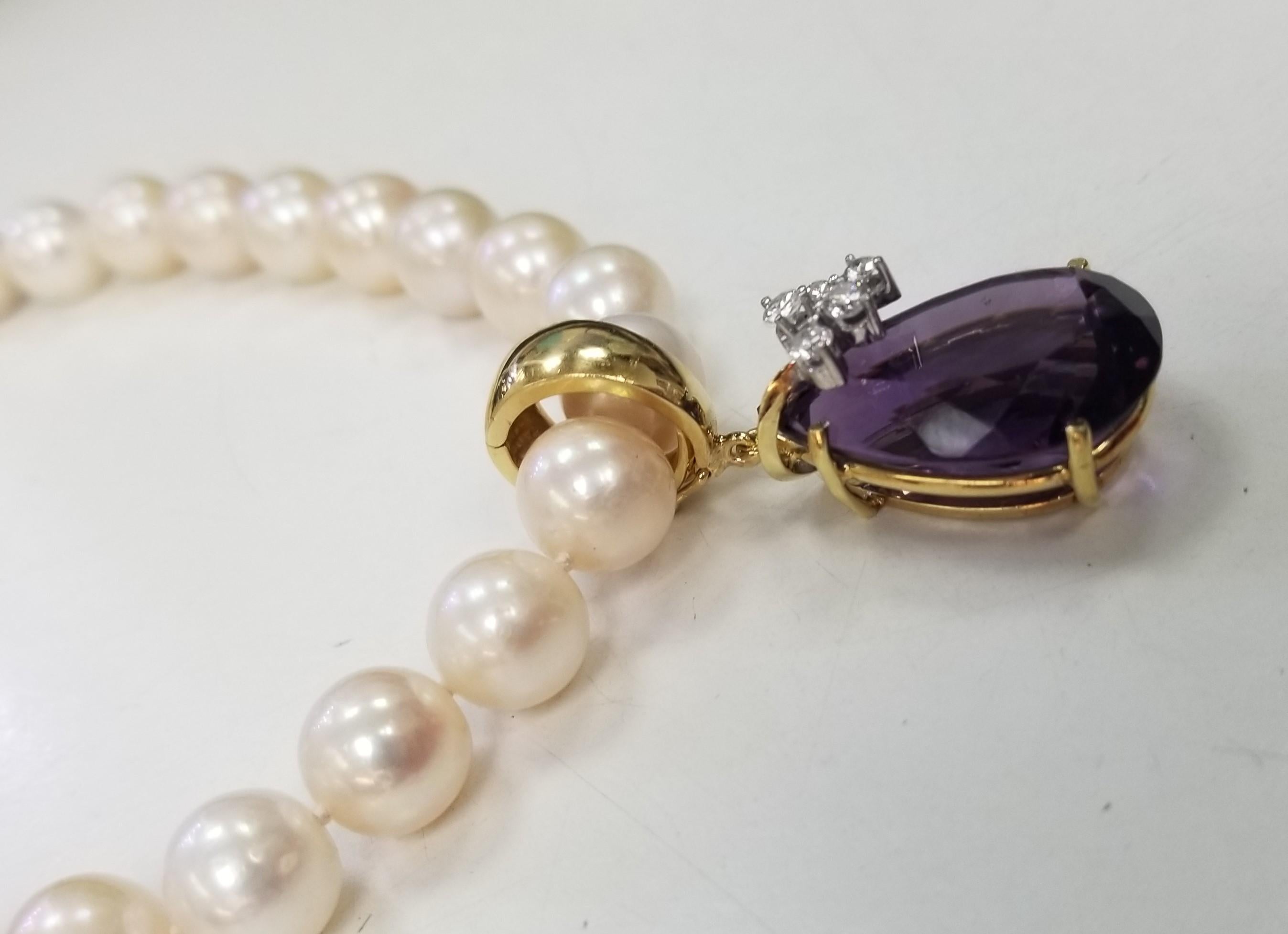 14k Yellow gold amethyst and diamond pendant, containing 1 
pear shape cut amethyst weighing 18.54cts. with 5 round full cut diamonds weighing .35pts. The piece is detachable on a 16 inch 9mm fresh water pearls. 