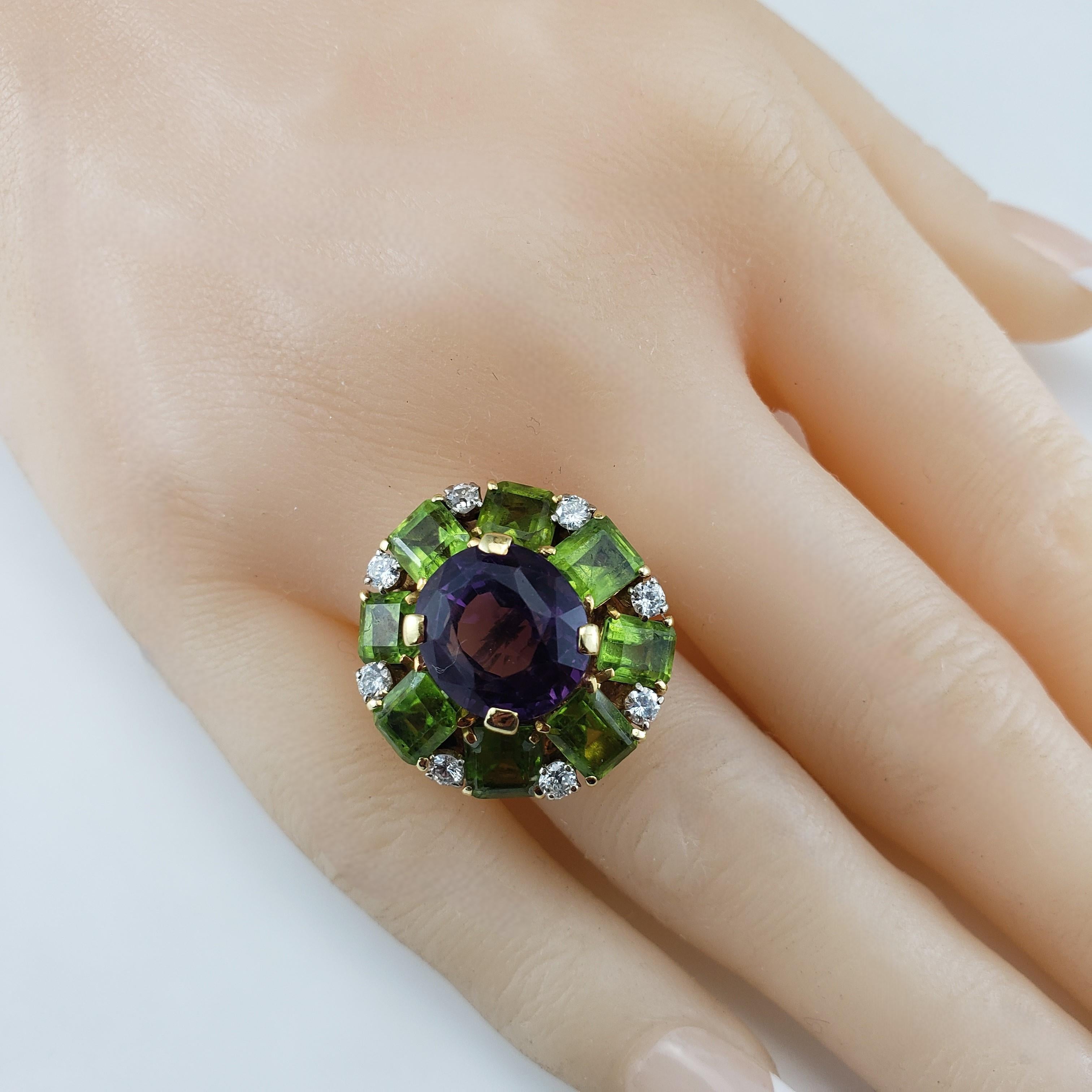 14 Karat Yellow Gold Amethyst, Diamond and Peridot Ring Size 7 JAGi Certified-

This stunning cocktail ring features one oval amethyst stone (12.5 mm x 11.3 mm) eight emerald cut peridot stones, seven round brilliant and one old mine cut diamonds