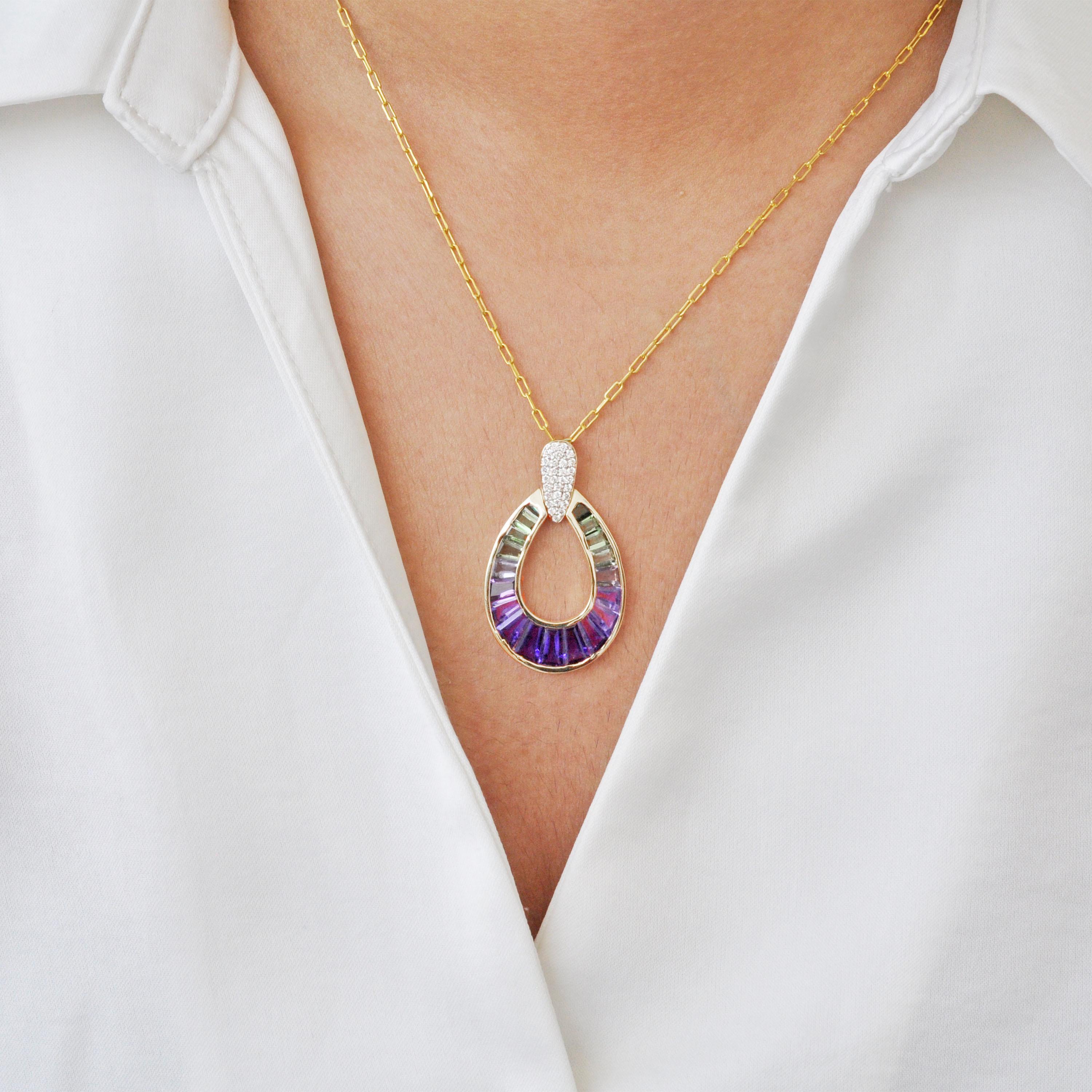 Prepare to be enchanted by our 14-karat yellow gold taper baguette amethyst green tourmaline raindrop diamond pendant necklace. Meticulously crafted, this masterpiece seamlessly blends elegance and sophistication.

Skilled artisans designed the