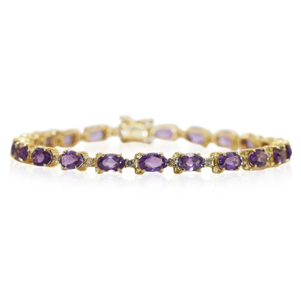 Ladies 14k yellow gold and amethyst bracelet.

Stamped 14k and weighs 11.8 grams gross weight, net 10.4 grams 14k gold.

There are 21 oval shape, amethysts, approximately 7.00 total carats.

In between amethysts are tiny diamonds.

The bracelet