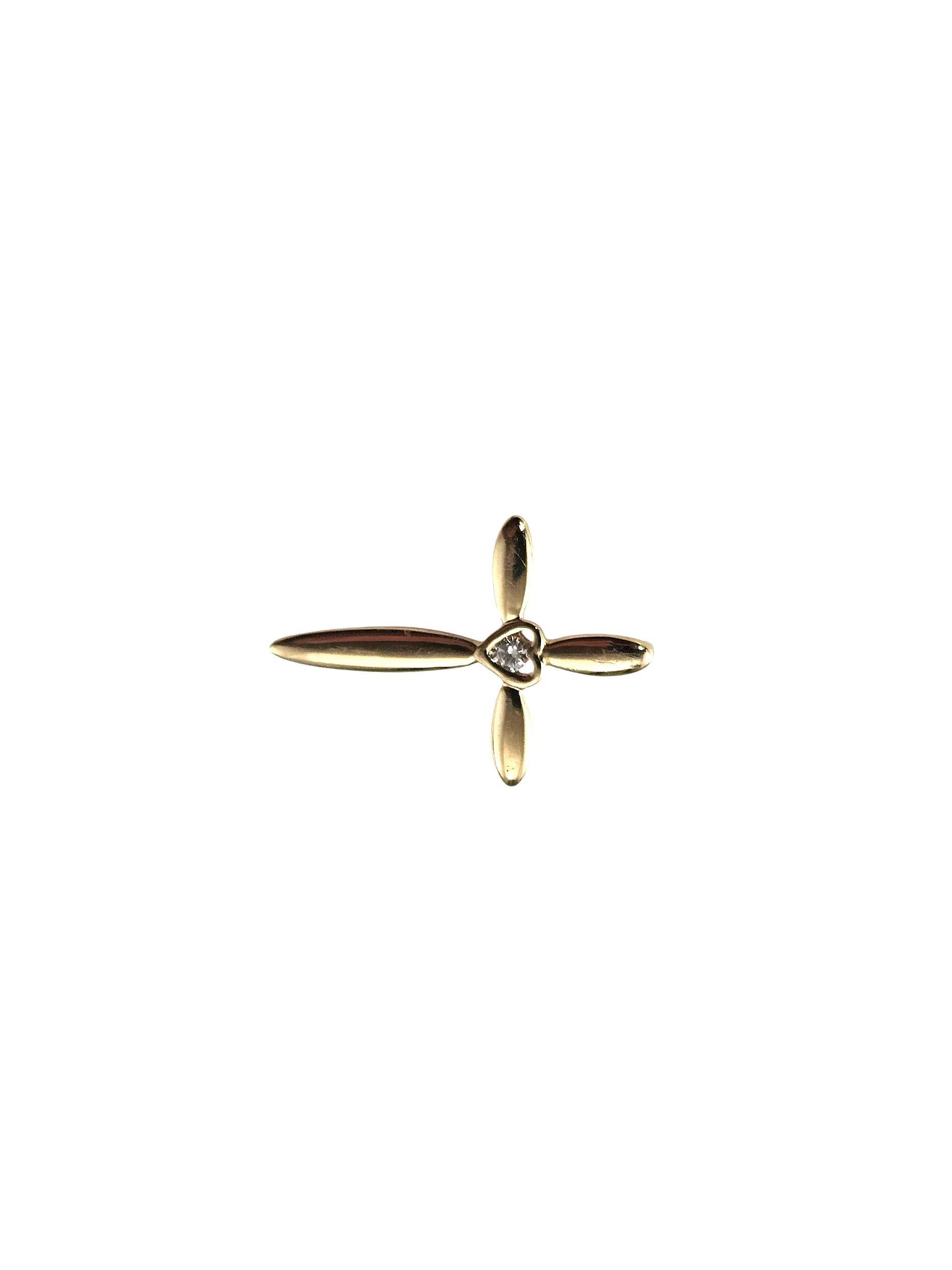 14K Yellow Gold and Diamond Cross Pendant-

This delicate 14K yellow gold cross pendant features a petite heart in its center accented with one round brilliant cut diamond, adding just the right amount of sparkle. Elegant, meaningful, and perfect