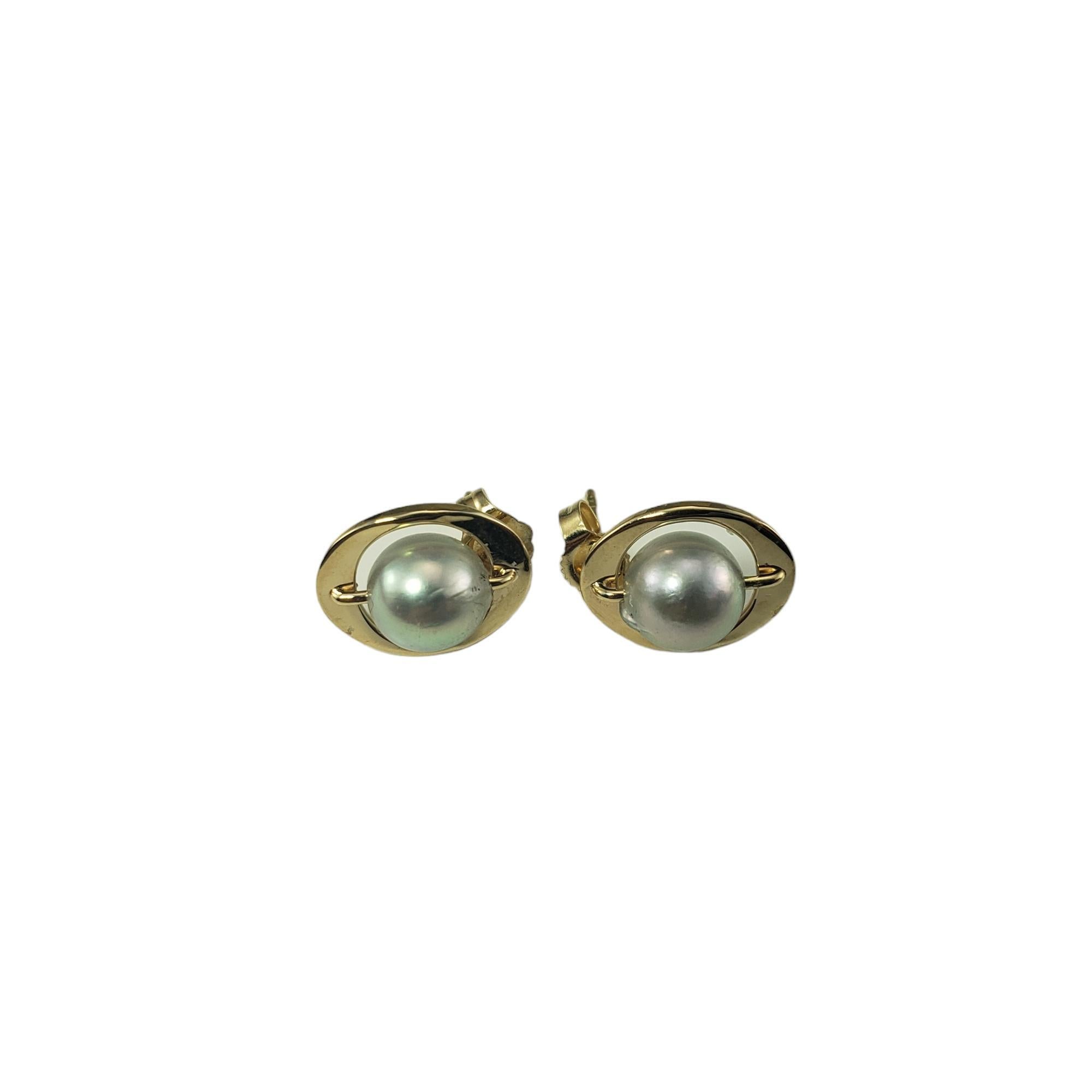 Vintage 14K Yellow Gold and Pearl Earrings-

These elegant earrings each feature one gray pearl (7 mm) set in classic 14K yellow gold.  Push back closures.

Size:  13 mm x 11 mm

Stamped: 14K

Weight: 1.4 dwt. / 2.2 gr.

Very good condition,