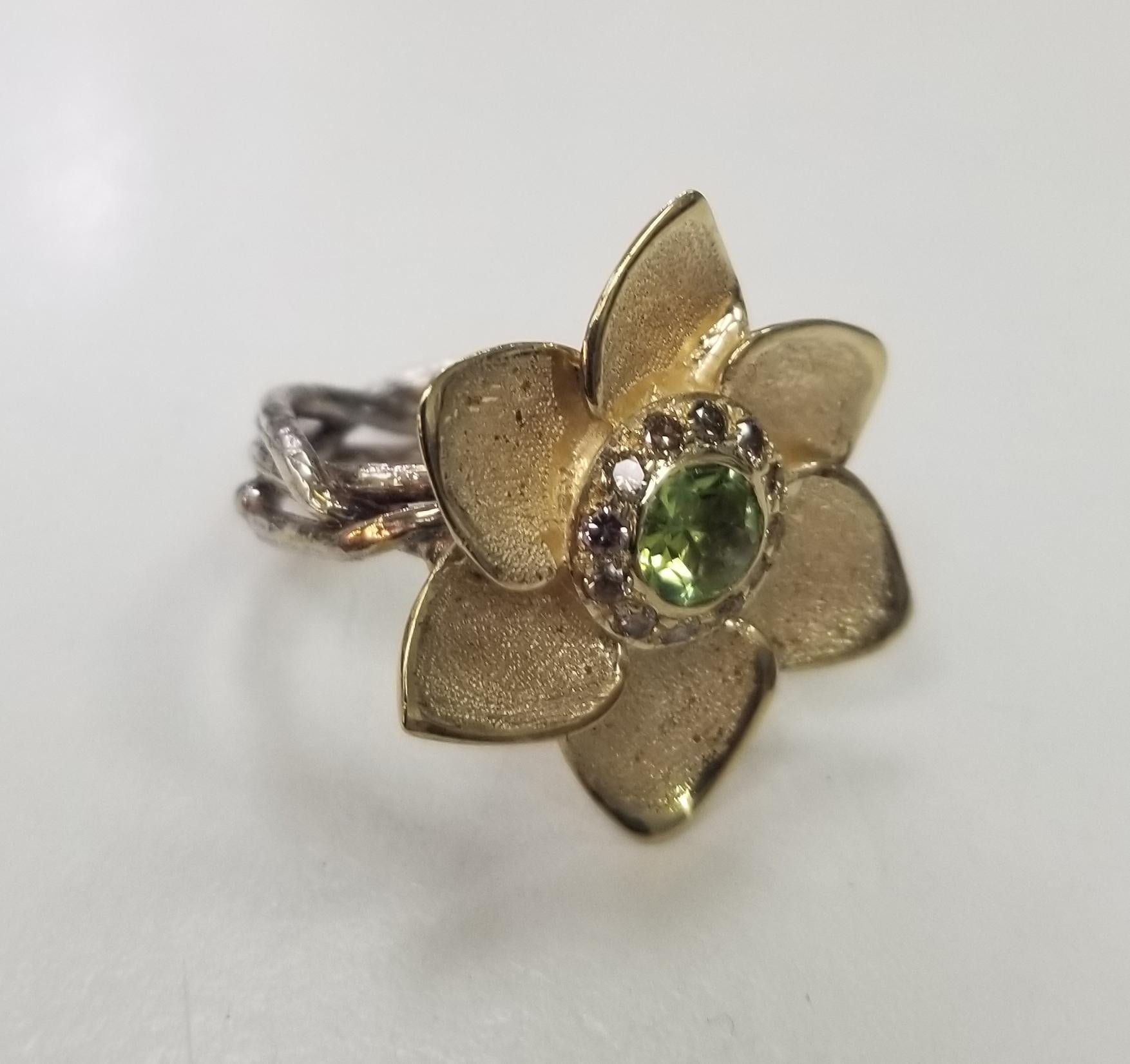 14k yellow gold and silver Gresha signature bark diamond ring containing 1 round peridot .53pts. and 12 brown diamonds weighing .30pts. set in a 6 pedal flower on a silver braided bark ring.  size 6.75 
*this design is ours and can be created in any