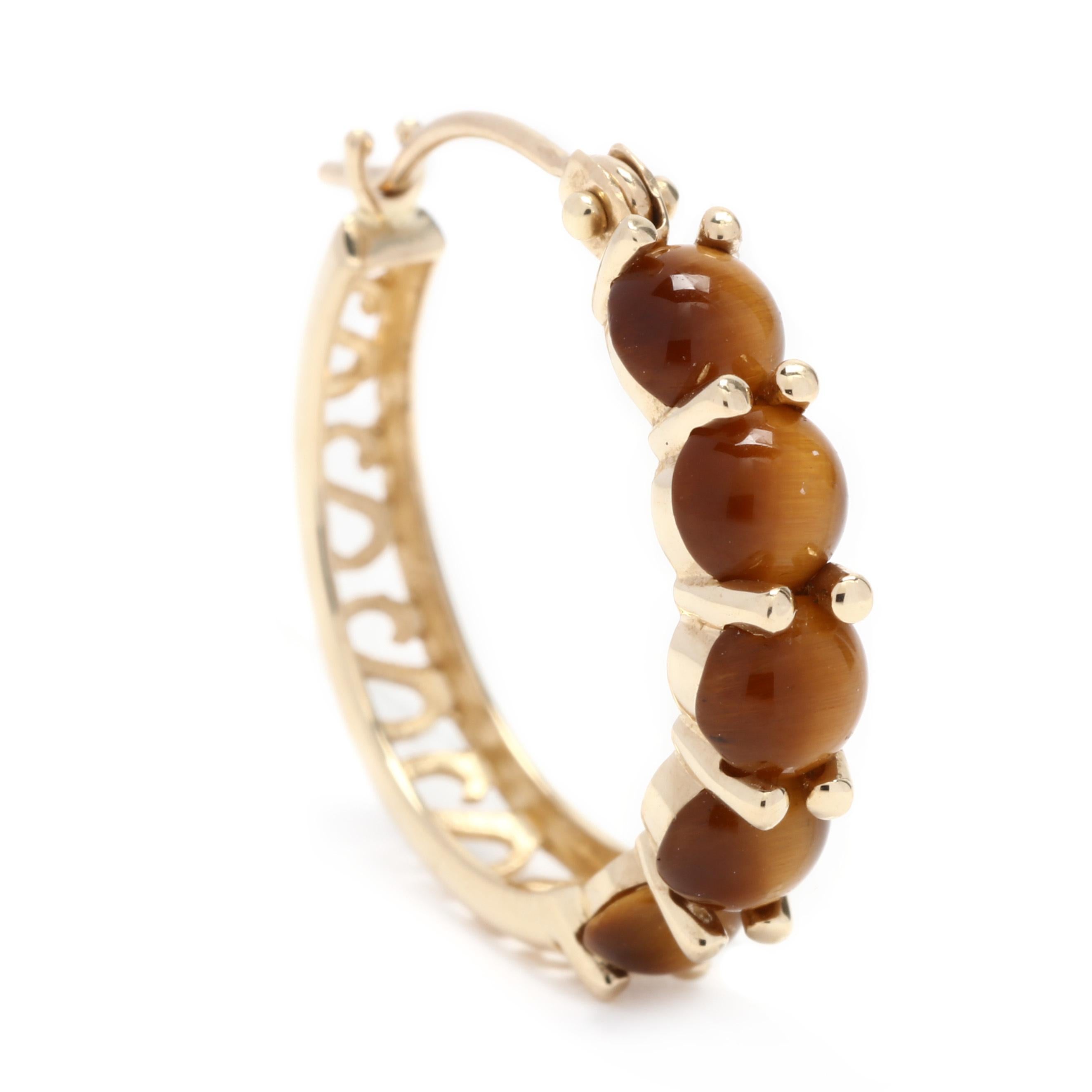 A pair of 14 karat yellow gold and tiger's eye hoop earrings. These earrings features ten round cabochon tiger's eye stones with a filigree backs and snap closures.

Stones:

- tiger's eye, 10 stones

- round cabochon

- 4.25 mm

Length: 3/4