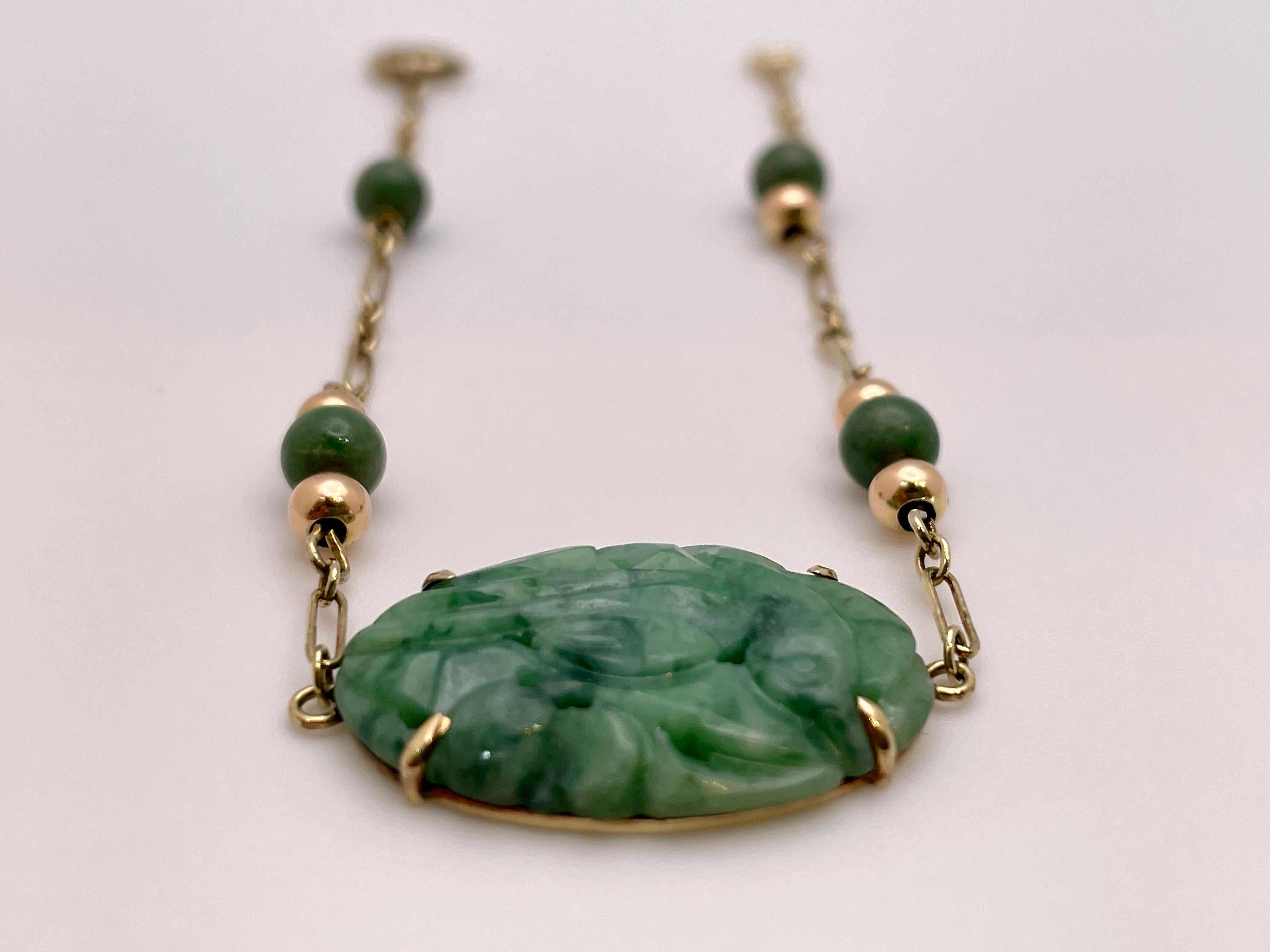 An original Victorian 14K yellow gold certified natural jade bracelet. Centered with one oval carved and pierced cabochon cut natural jade omphacite, measuring approximately 23.00 x 15.50 x 2.75 MM, weighing approximately 9.00 CT, and colored green