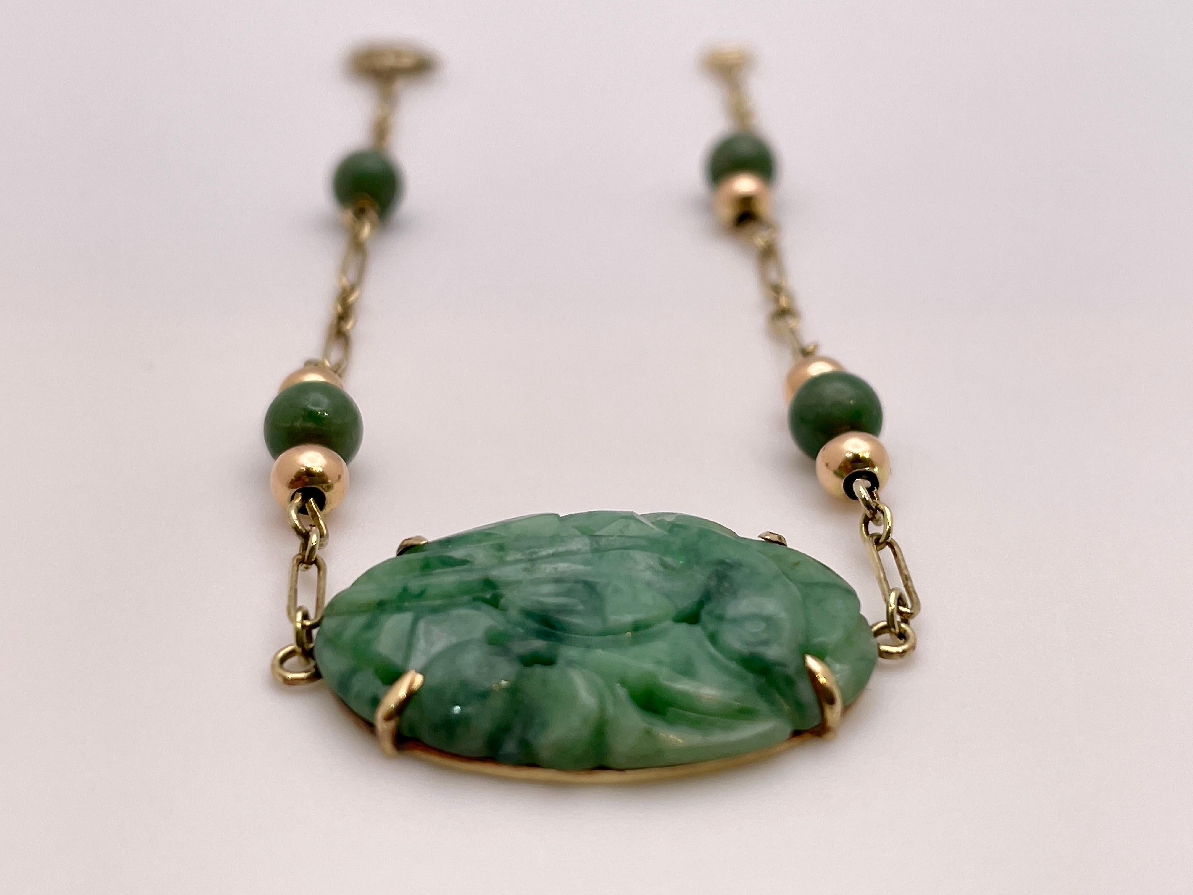 An original Victorian 14K yellow gold certified natural jade bracelet. Centered with one oval carved and pierced cabochon cut natural jade omphacite, measuring approximately 23.00 x 15.50 x 2.75 MM, weighing approximately 9.00 CT, and colored green