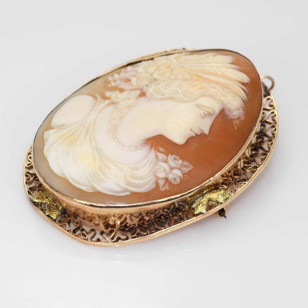 Hand made antique cameo brooch in 14k yellow gold setting.
The gold tests 14k. Gross weight of the brooch is 13 grams.
The cameo is hand carved from giant conch shell.
The bezel has delicate filigree work.
The brooch measures 2 x 1 1/2 inches.
Good