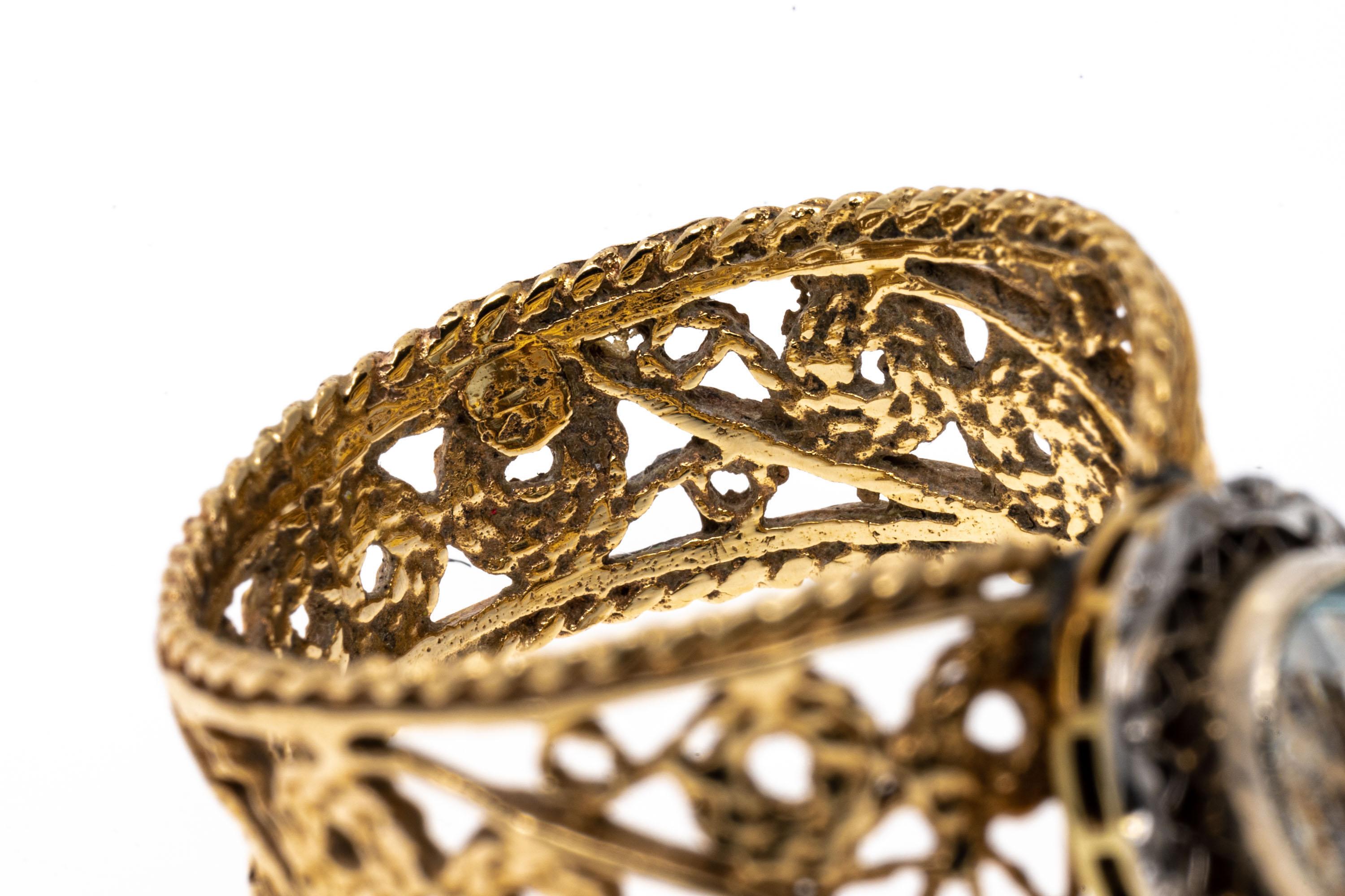14k yellow gold ring. This stylized filigree 