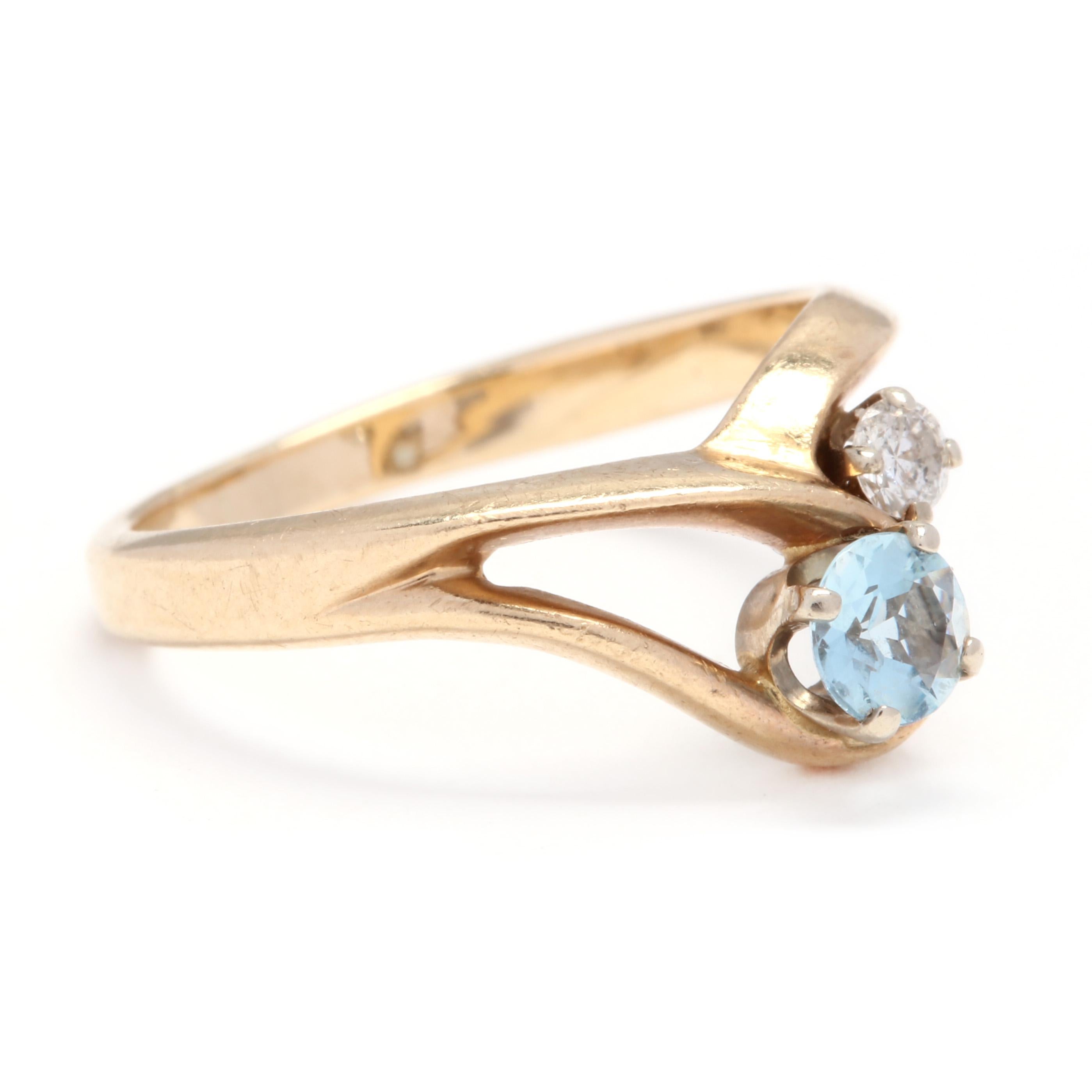 14k yellow gold aquamarine and diamond minimalist ring. A simple, free form ring with a round aquamarine that's approximately 0.24 carats with a 0.06 carat round diamond set next to it. This is a great piece for someone young or those who appreciate