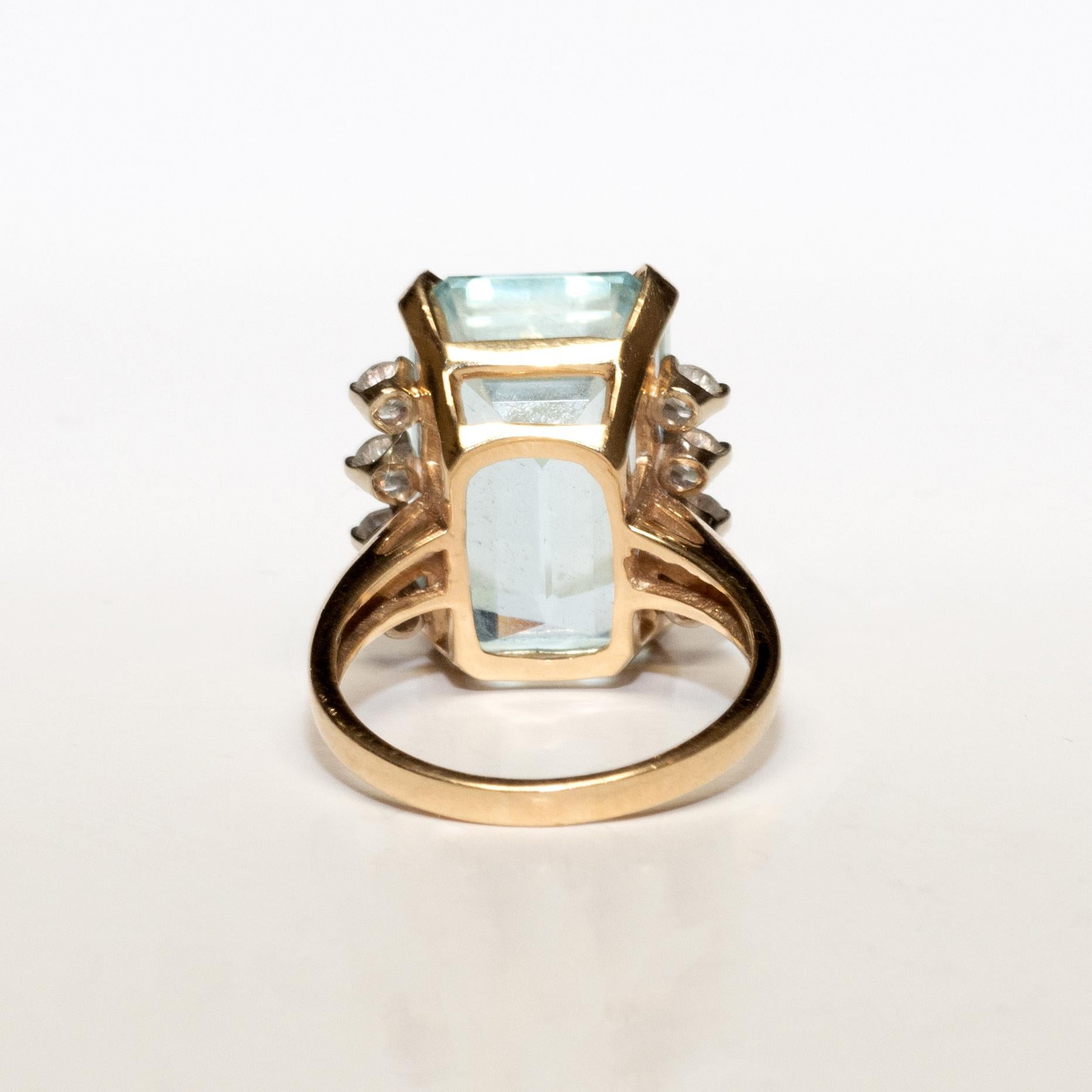 Ladies aquamarine and diamond ring in 14k yellow gold.
Stamped 14k and weighs 7.6 grams.
The aquamarine is triangle shaped with a step cut, 14.50 carats, pale blue color.
On the sides are round brilliant cut diamonds, .50 total carats, G color, VS