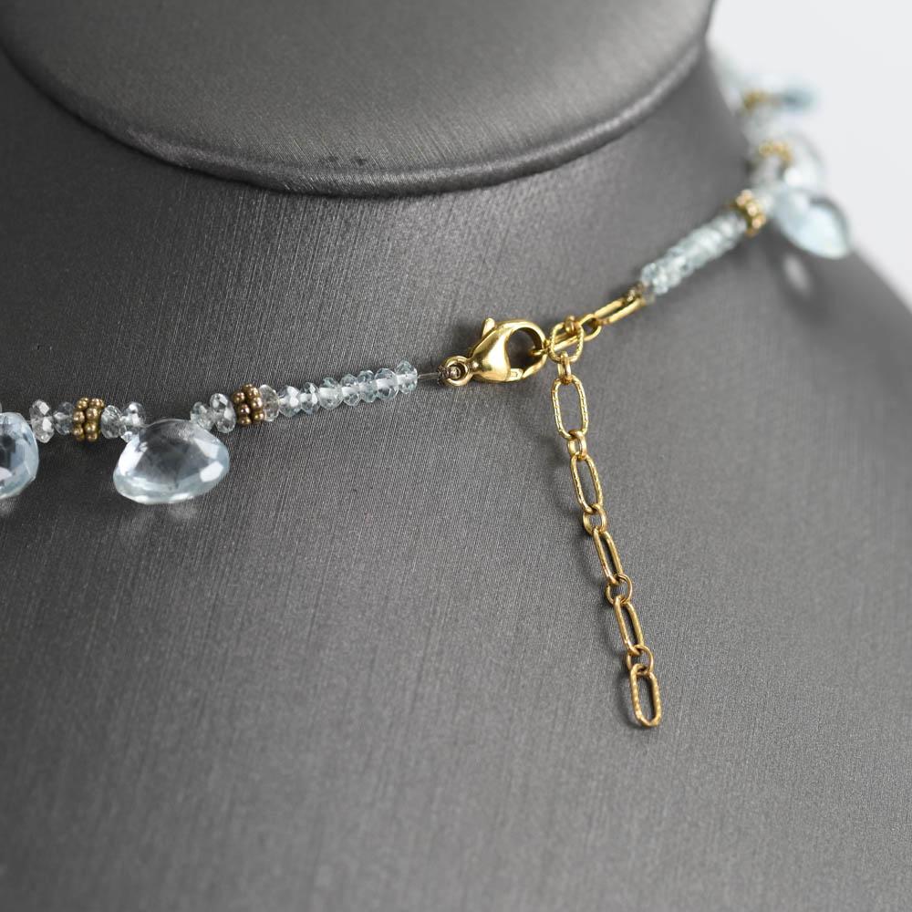 Ladies aquamarine necklace with 14k yellow gold clasp.
The aquamarines are faceted pear shapes, approximately 80 carats, light blue color, slightly included.
The necklace measures 16 inches long.
Excellent condition.