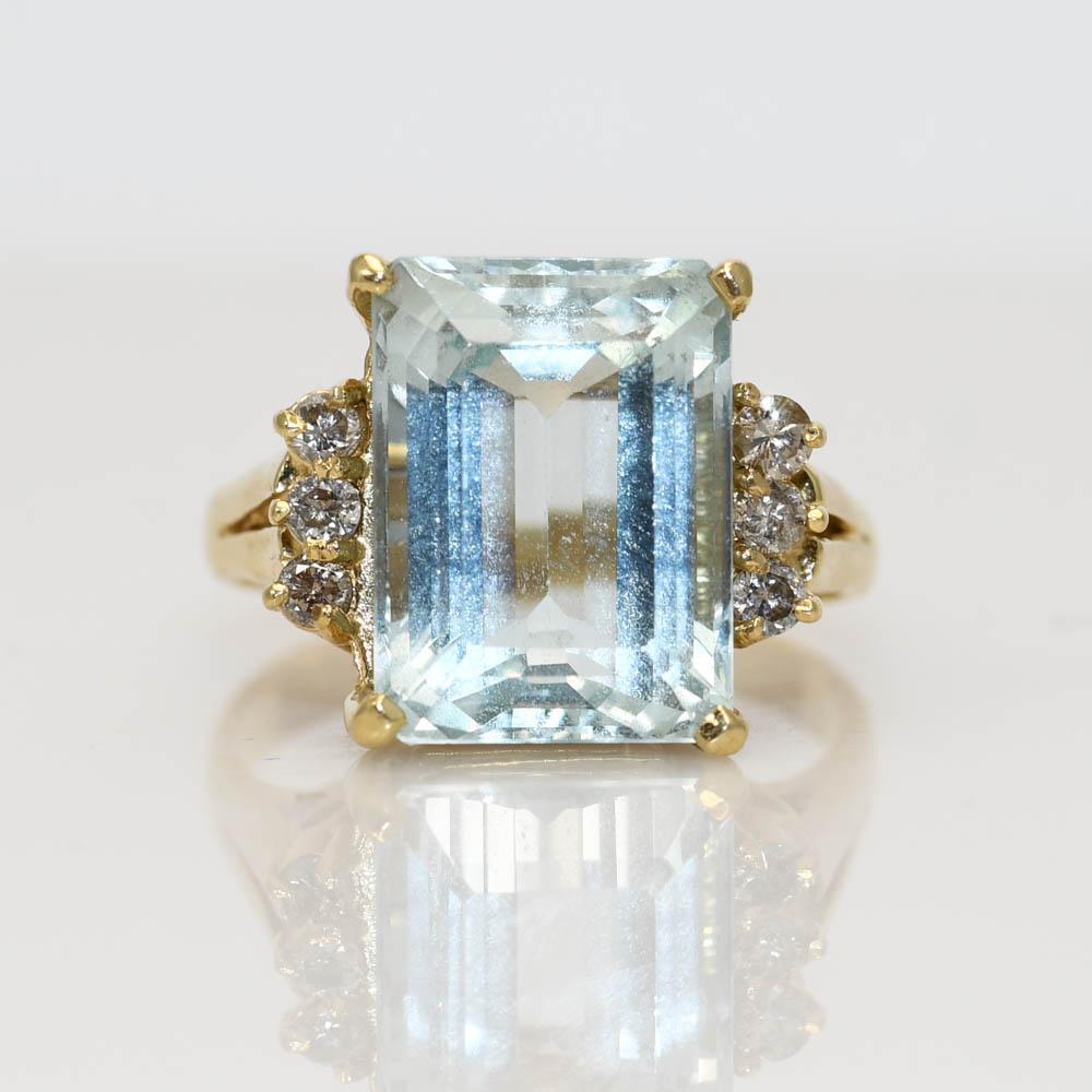Ladies aquamarine and diamond ring. 
Stamped 14k and weighs 4.5 grams gross weight.
The aquamarine is an emerald cut, 5.00 carats, light blue color.
The side diamonds are round brilliant cuts, .15 total carats, k,m,l color range, Si clarity.
Ring