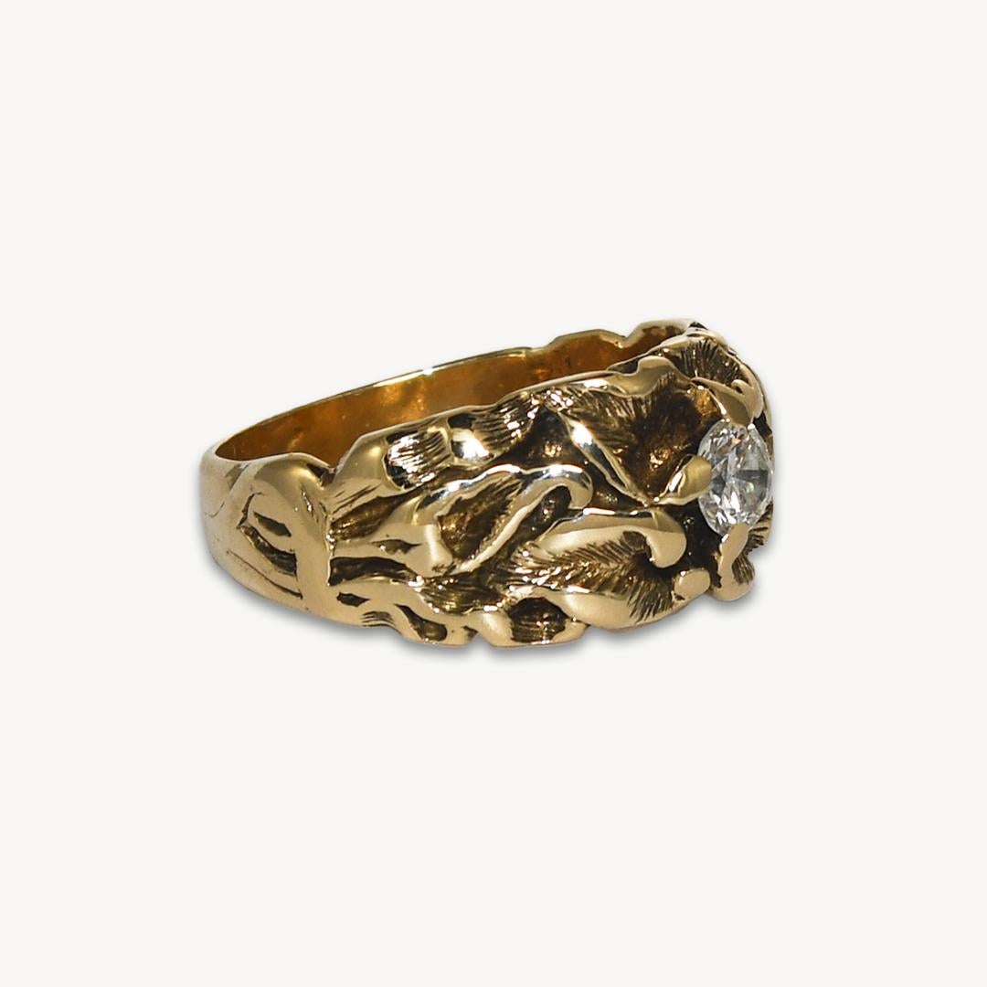 Art Nouveau style ring in 14k yellow gold with 1 diamond.
Circa 1960. Marked 14k and weighs 6.7 grams.
The design is of a calalilly.
The center diamond is a round brilliant cut, .33ct, g to h color, si clarity.
The diamond has a small chip