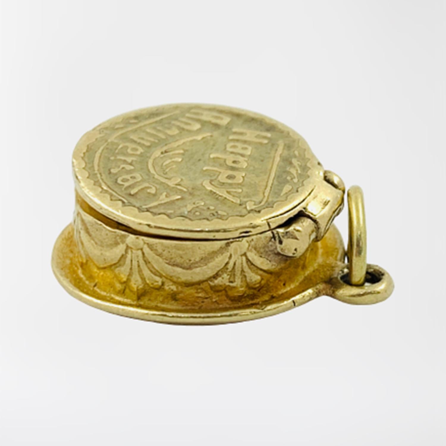 Vintage Anniversary Cake Charm circa 1930-40's

Crafted of solid 14K yellow gold, this cake shaped charm opens to reveal a little candle on the inside. The outside of the cake features gorgeous engraved patterns and unique touches that make the cake