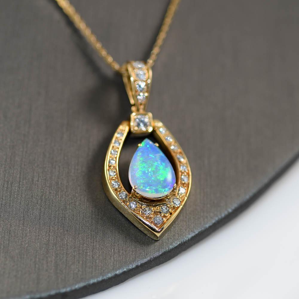 14K Yellow Gold Australian Opal & Diamond Pendant .75tdw, 11g
Ladies Australian opal and diamond pendant necklace.

Stamped 14k and weighs 11 grams gross weight.

The opal is solid piece not a doublet.

Attractice blue and green colors from every