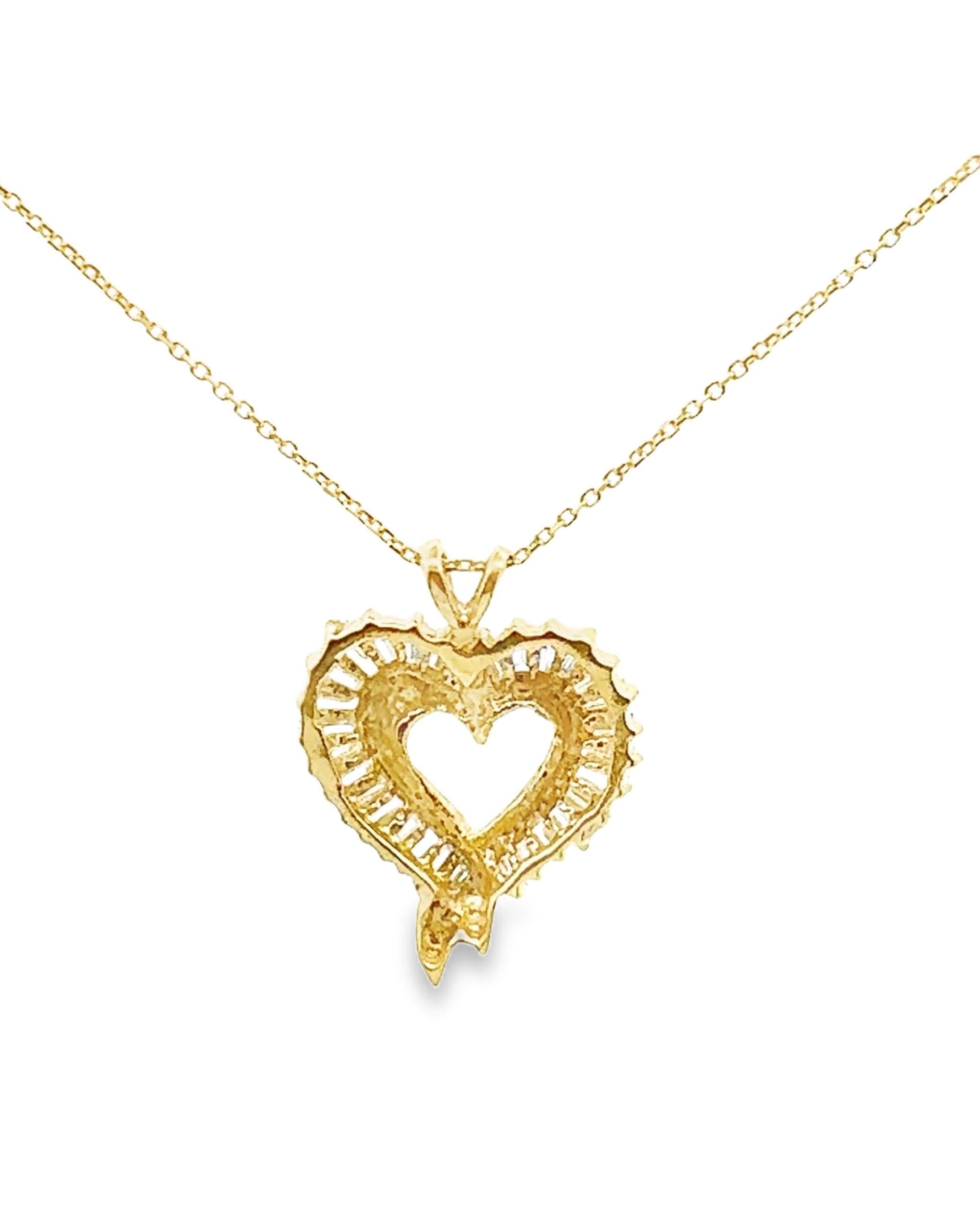 Pre-Owned 14K yellow gold heart pendant necklace with 29 tapered baguette diamonds weighing approximately 1.5 ct total. 

*F/G color, VS2 clarity
